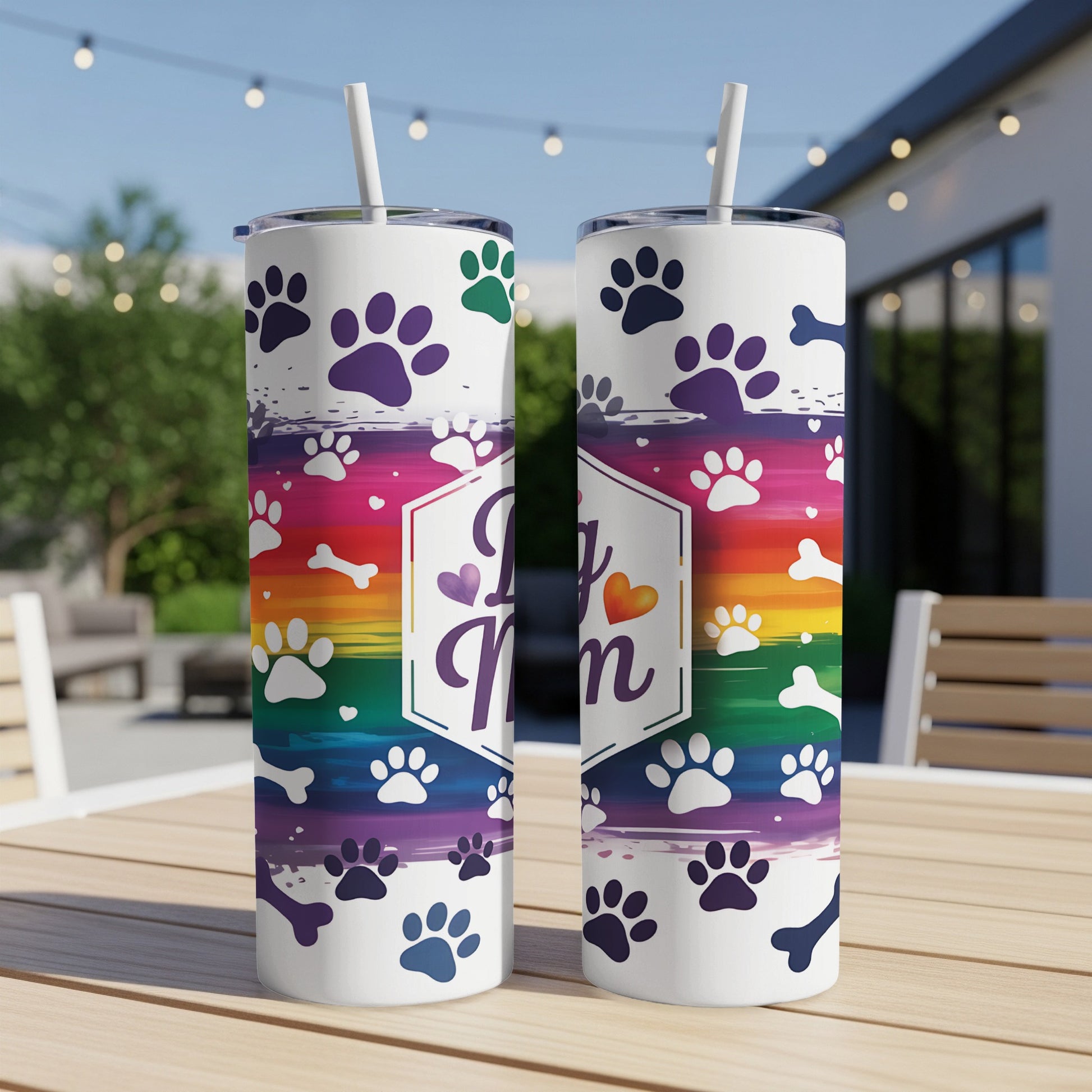 White tumbler with "Dog Mom" text and rainbow paw print design.