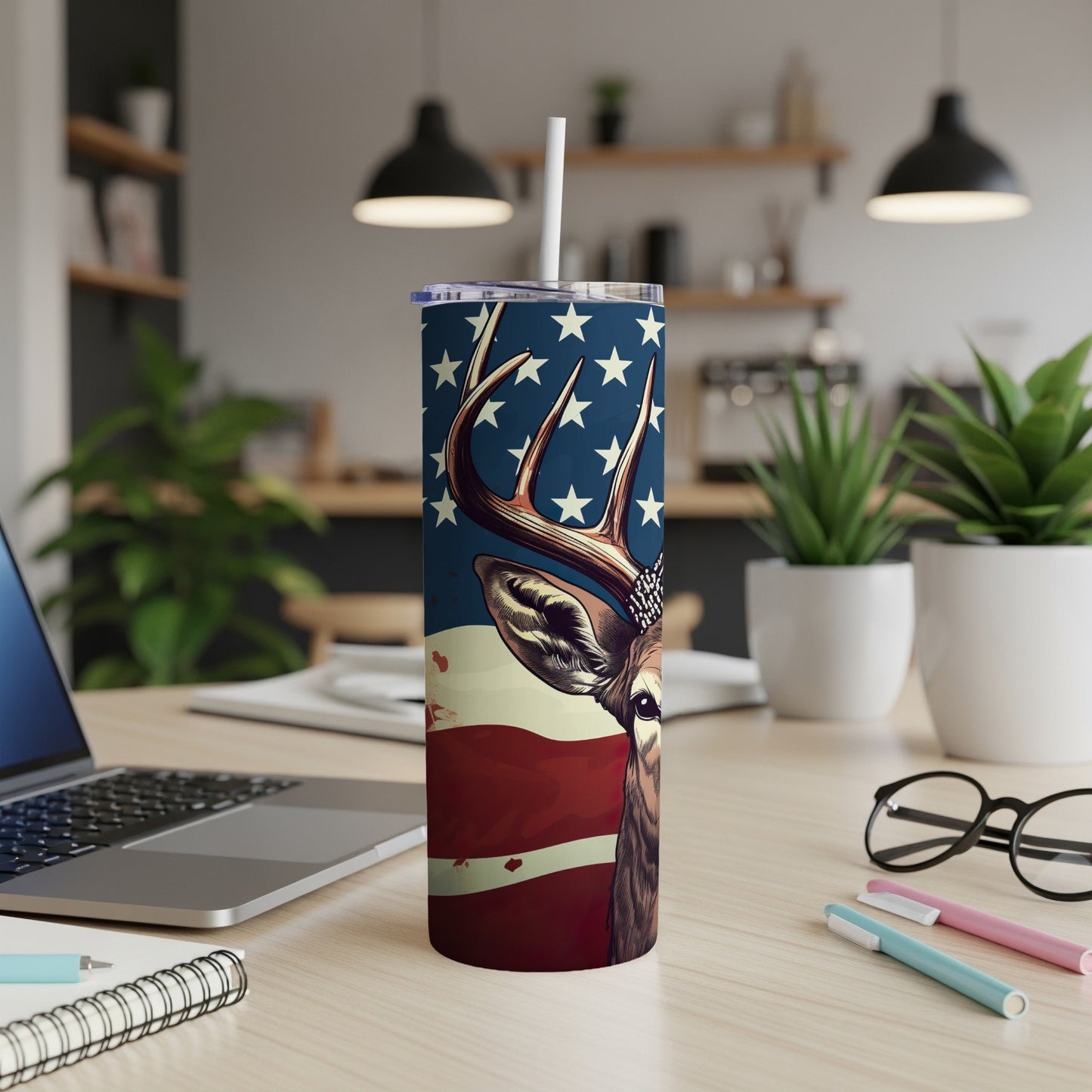 Deer head with American flag pattern on a tumbler with straw.