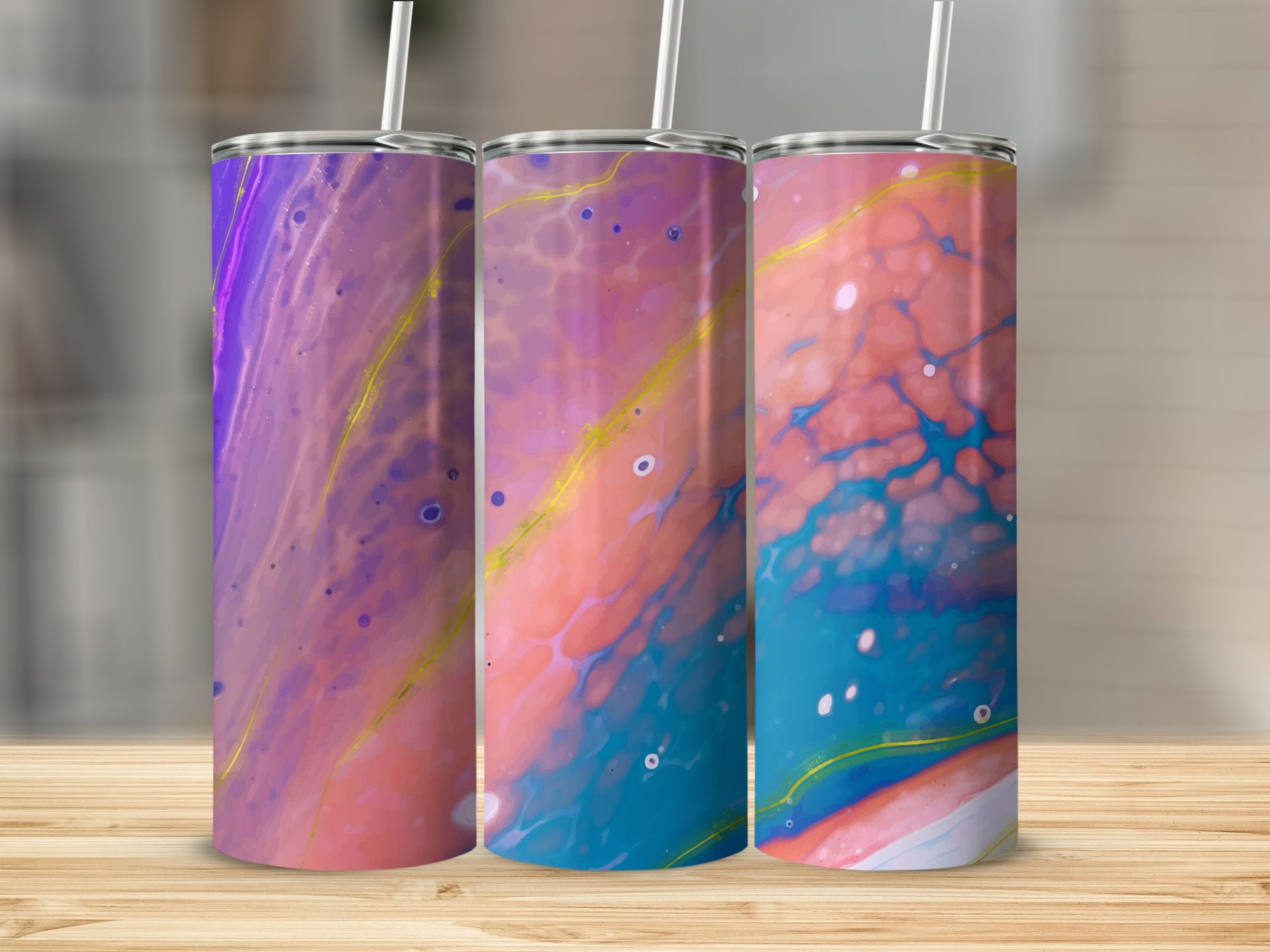 Three tumblers with vibrant, abstract marbled patterns in purple, pink, blue, and gold.