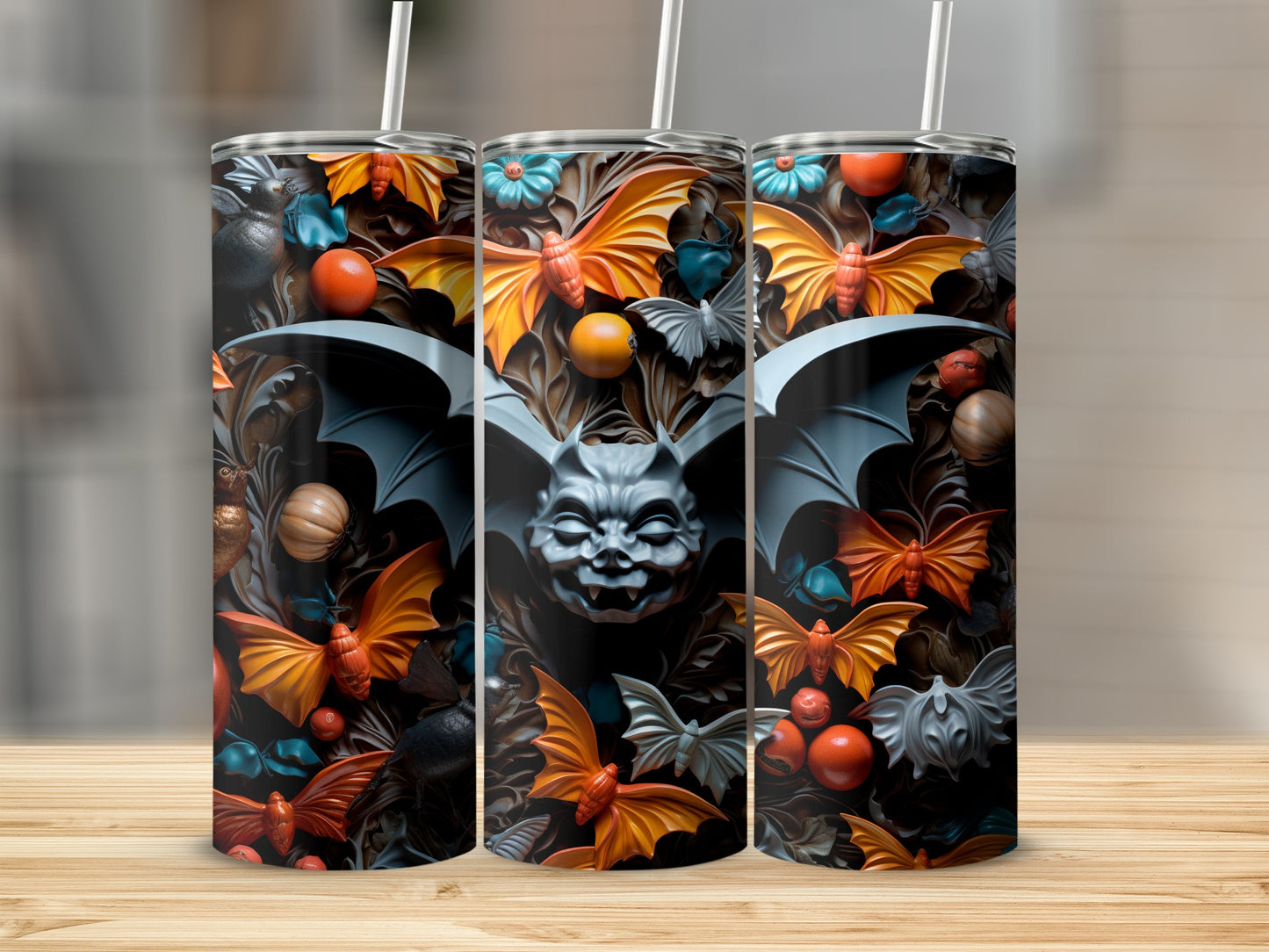 Three tumblers with a Halloween-themed design featuring bats, pumpkins, and floral elements.