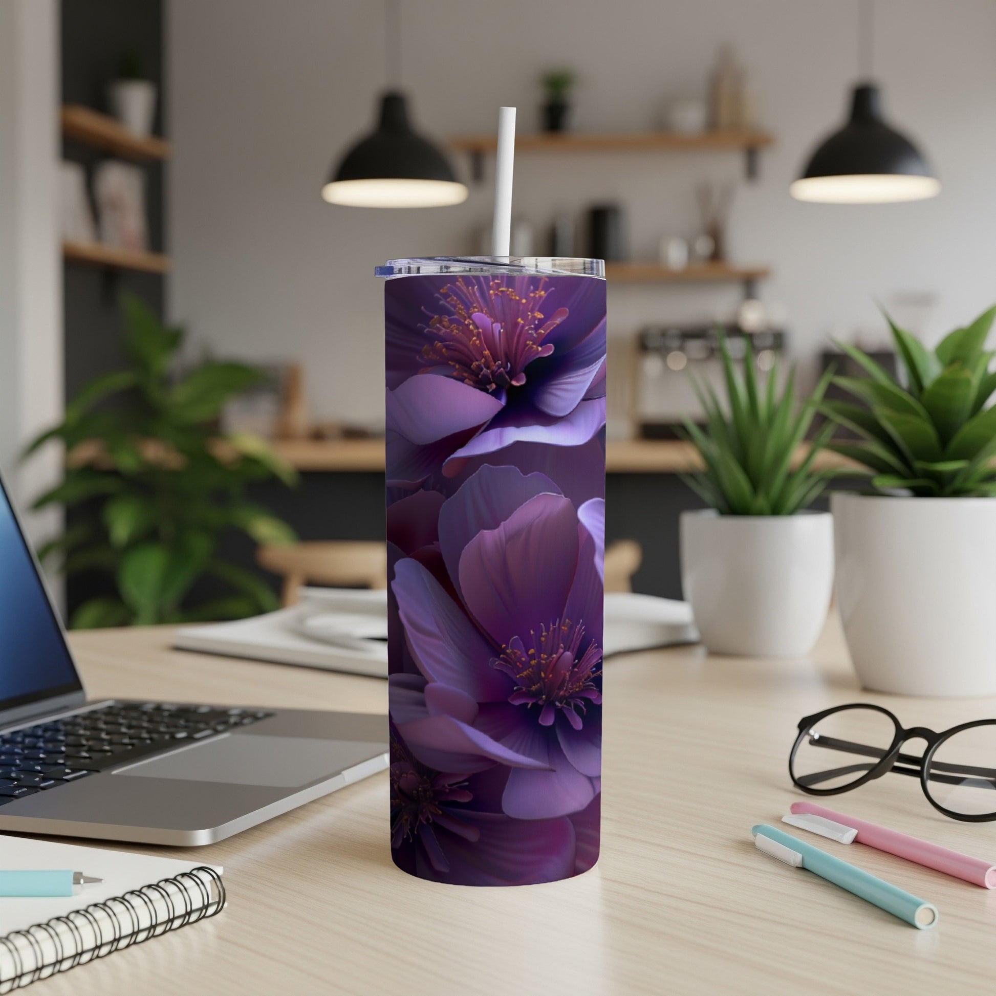 Purple floral tumbler with lid and straw on a desk.