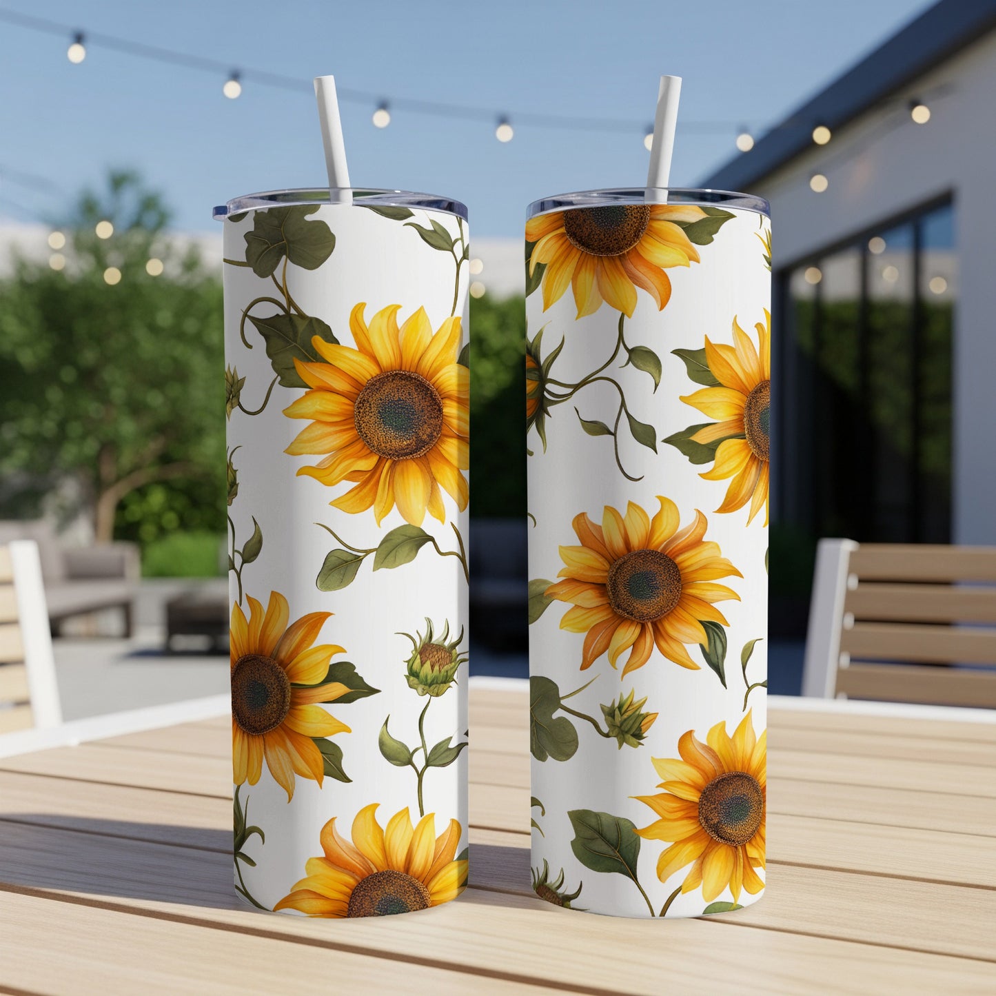 Two white tumblers with a repeating sunflower and leaf pattern.