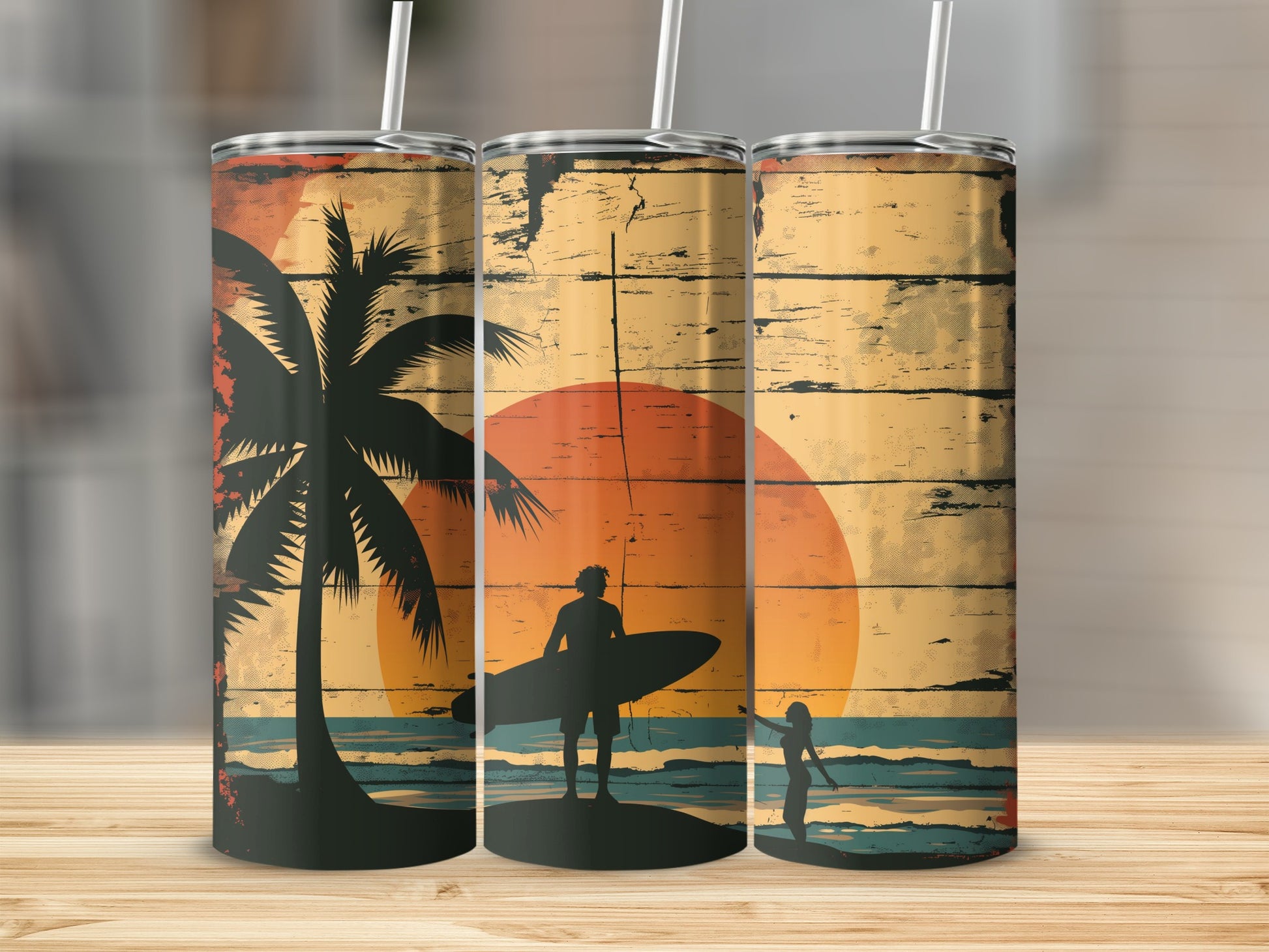 Three tumblers with a beach sunset and surfer design.