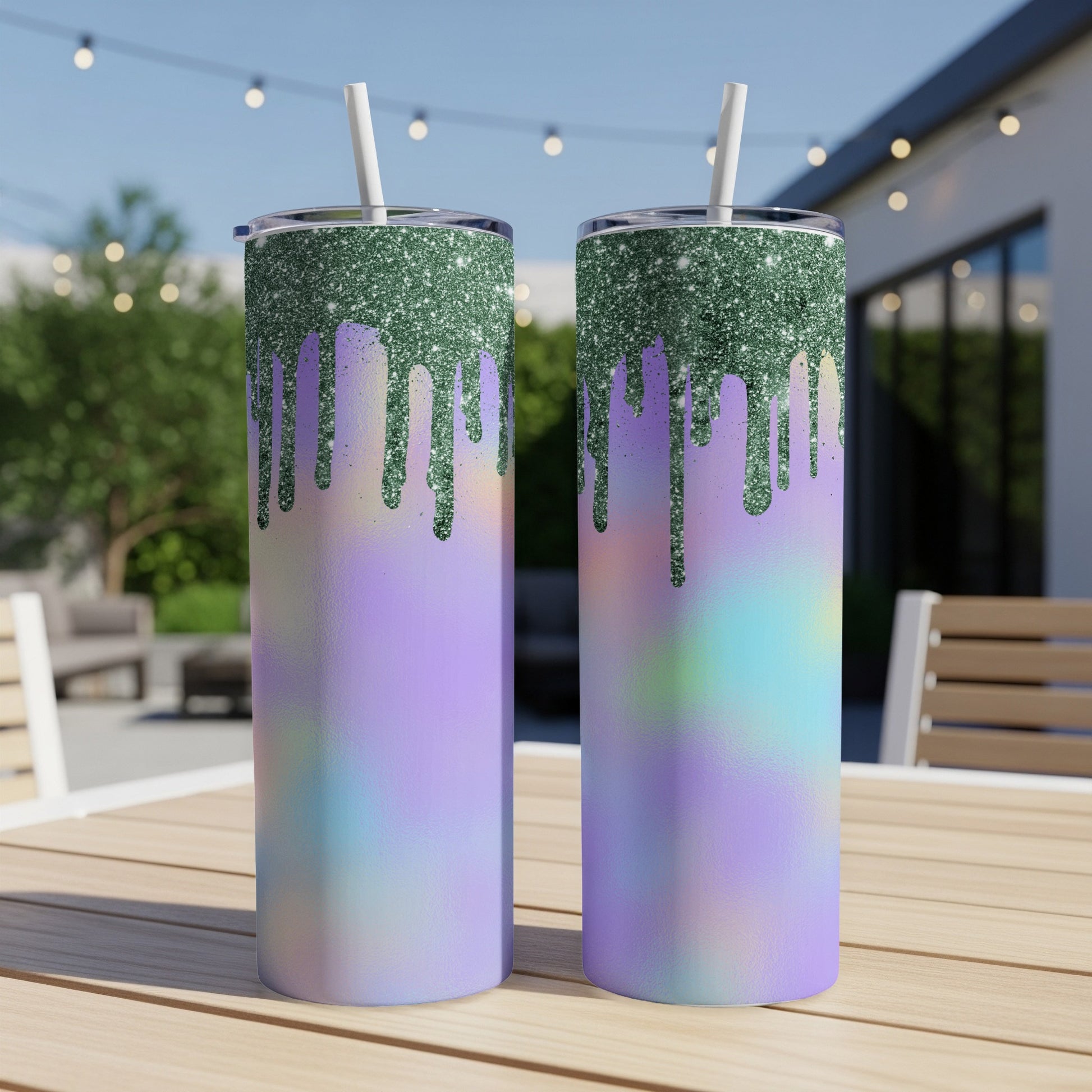 Two glitter-drip tumblers with purple and blue tie-dye pattern displayed outdoors.