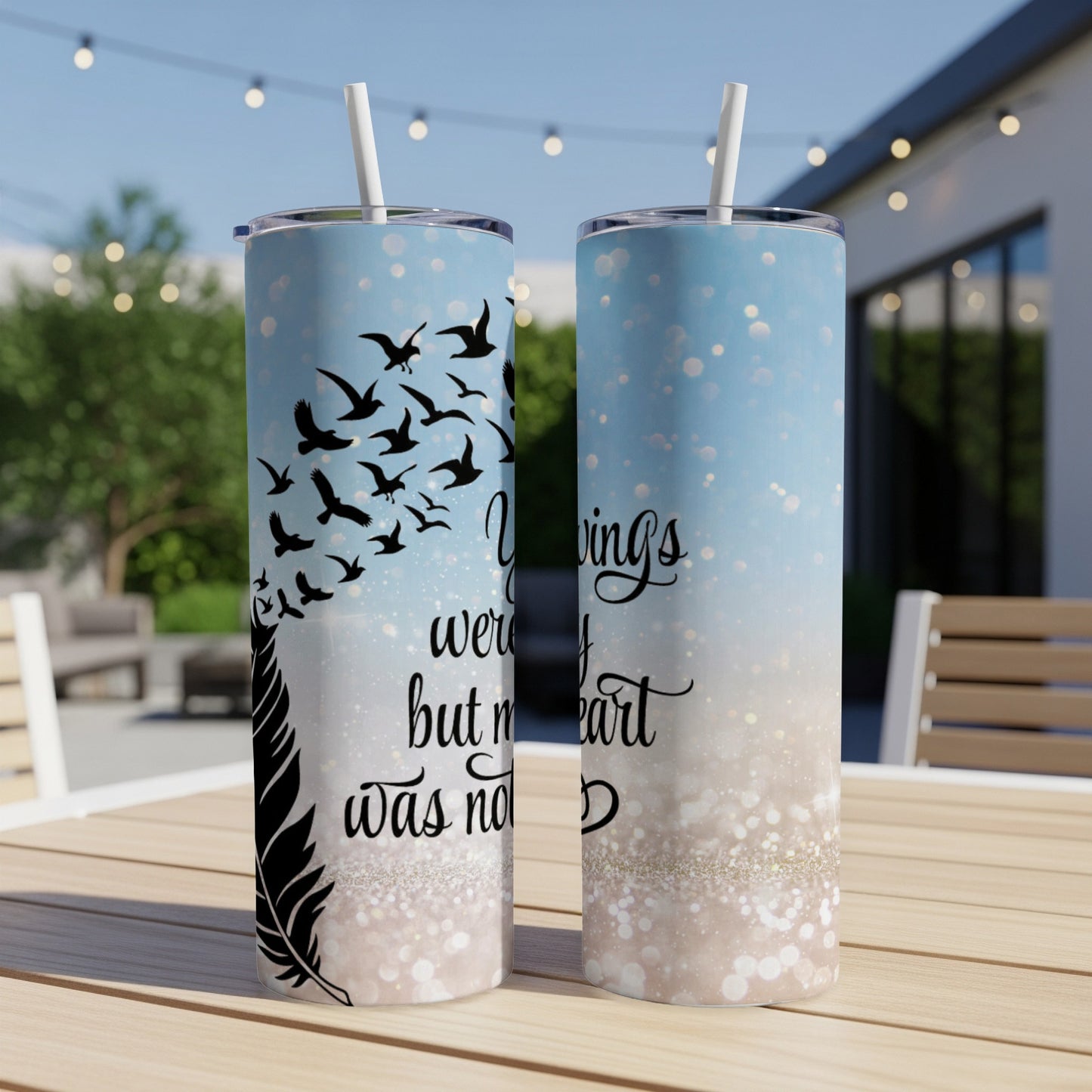 Two tumblers with a feather and birds design, one reading "wings were but not my heart."