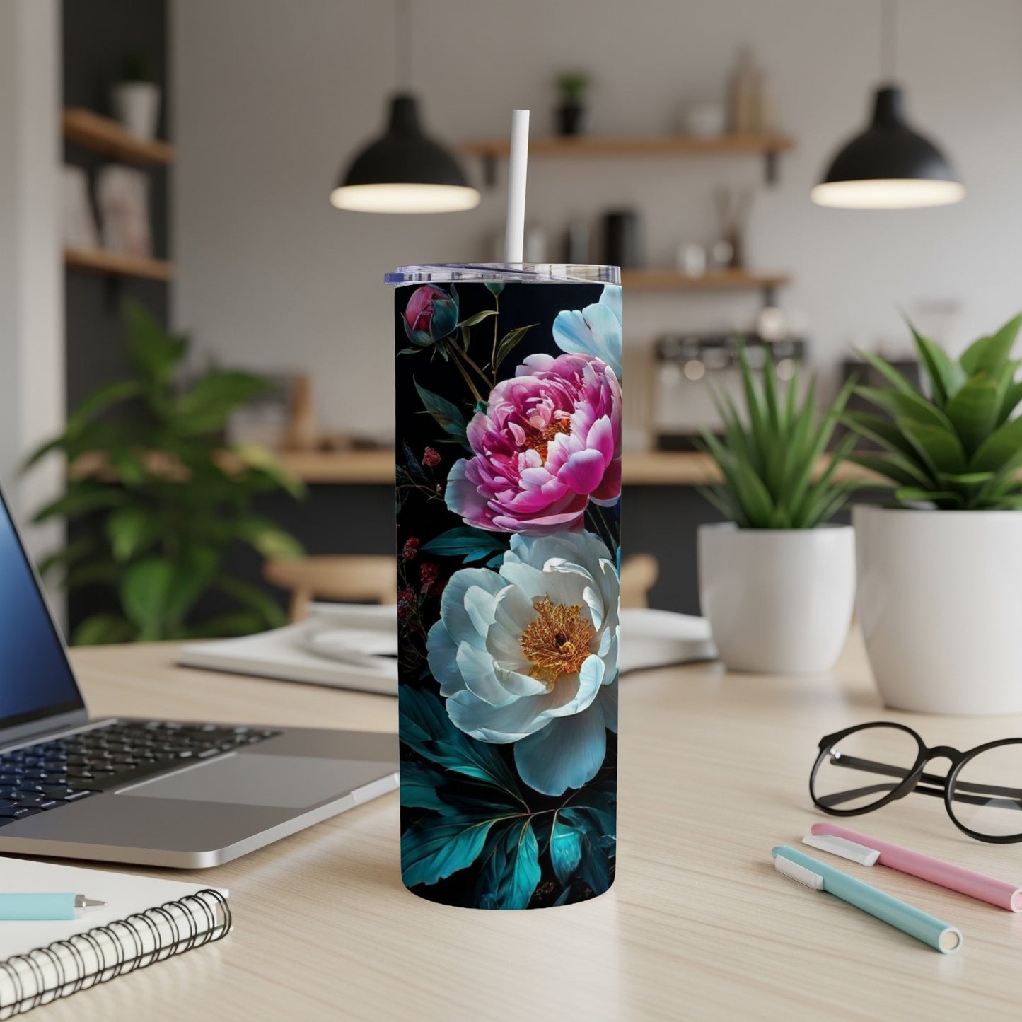 White and pink peonies on a black background adorn a tumbler on a desk.