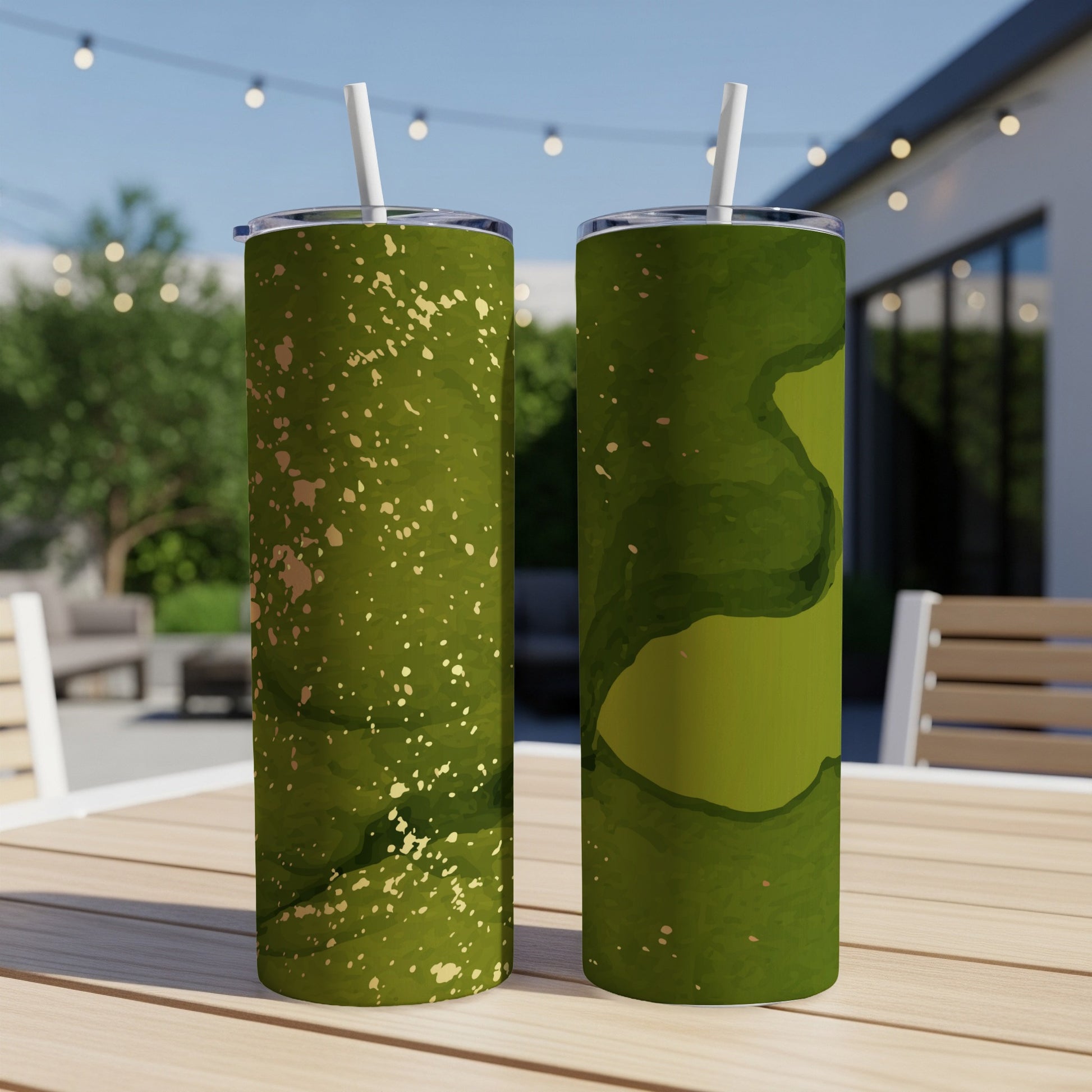 Two green tumblers with gold speckles on a table.