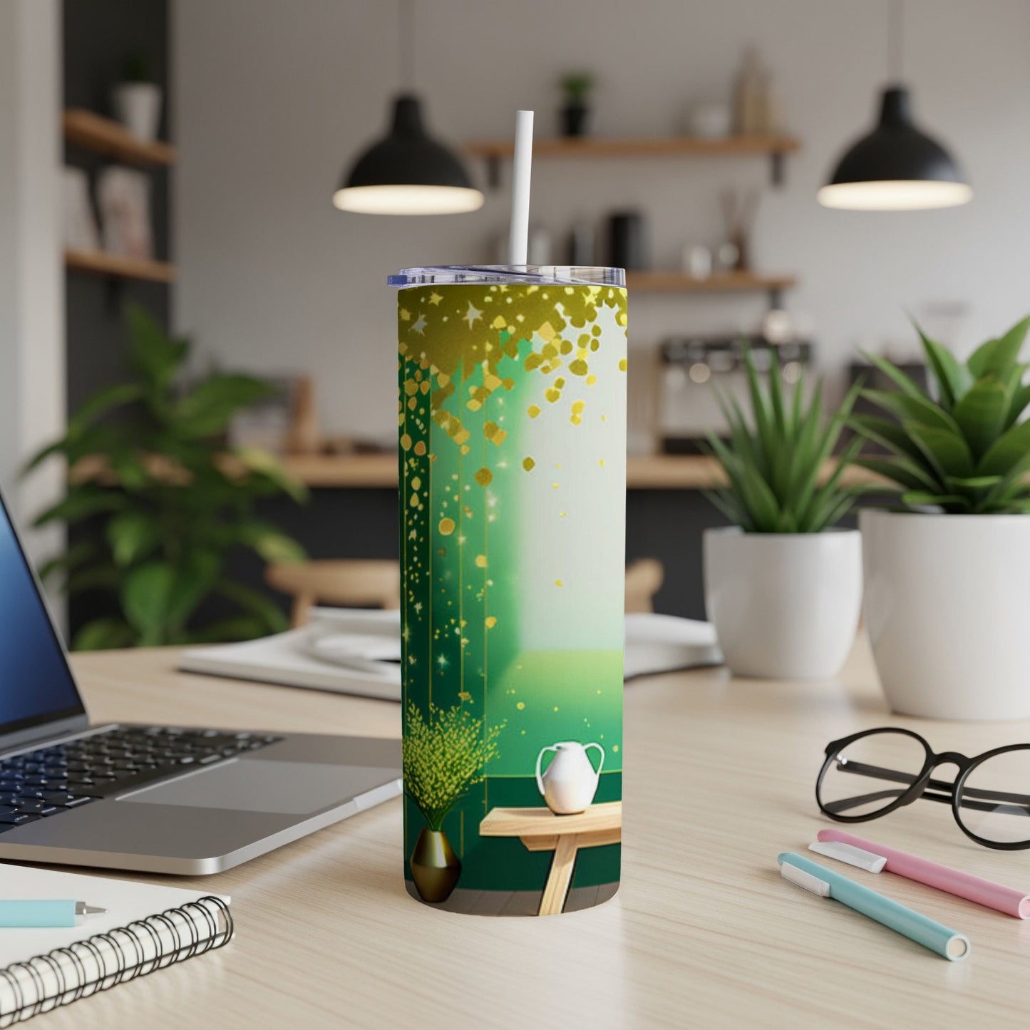 Green and gold speckled tumbler with a white straw on a desk.