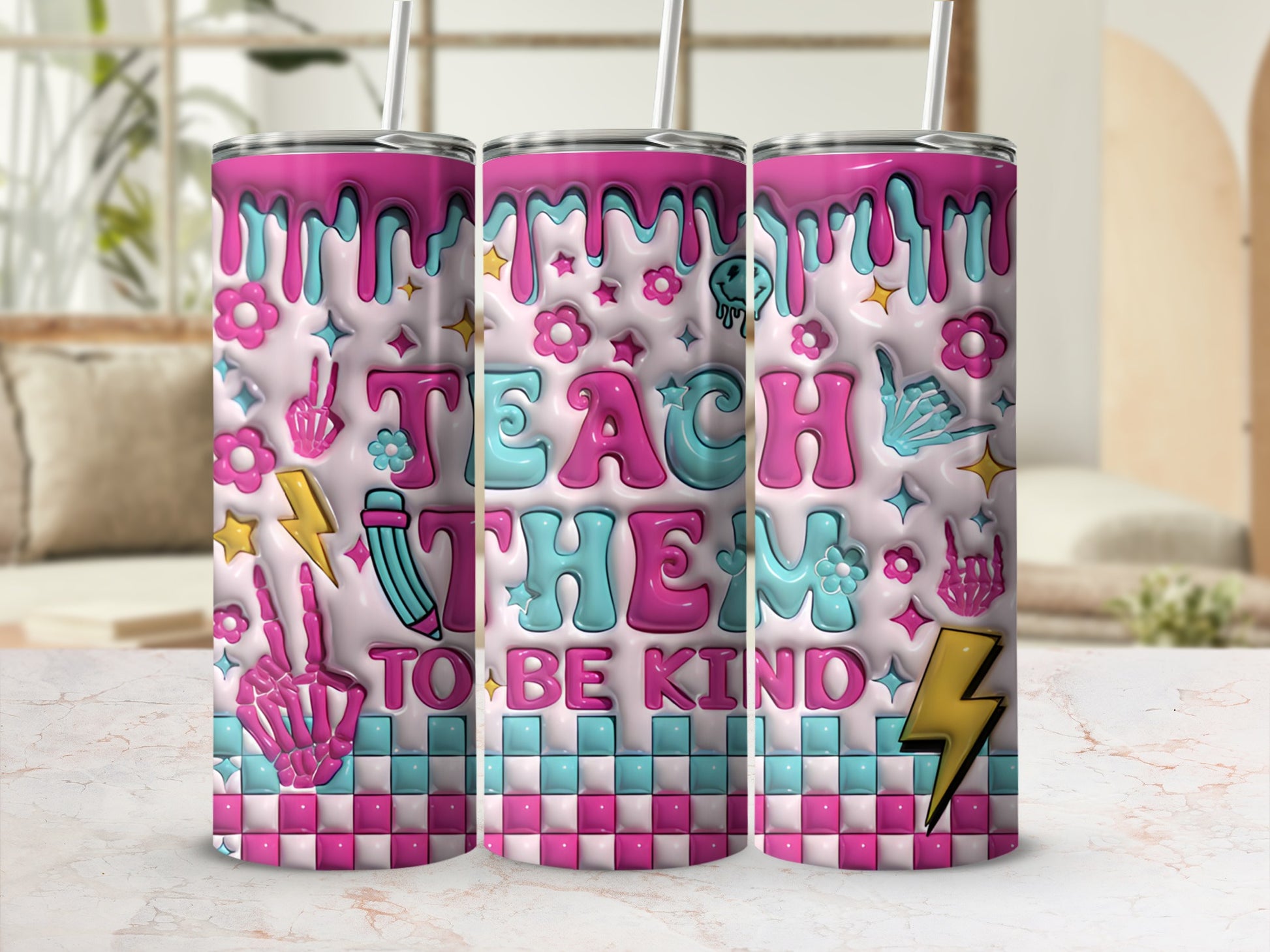Tumbler with "Teach Them To Be Kind" text and playful pastel graphics.