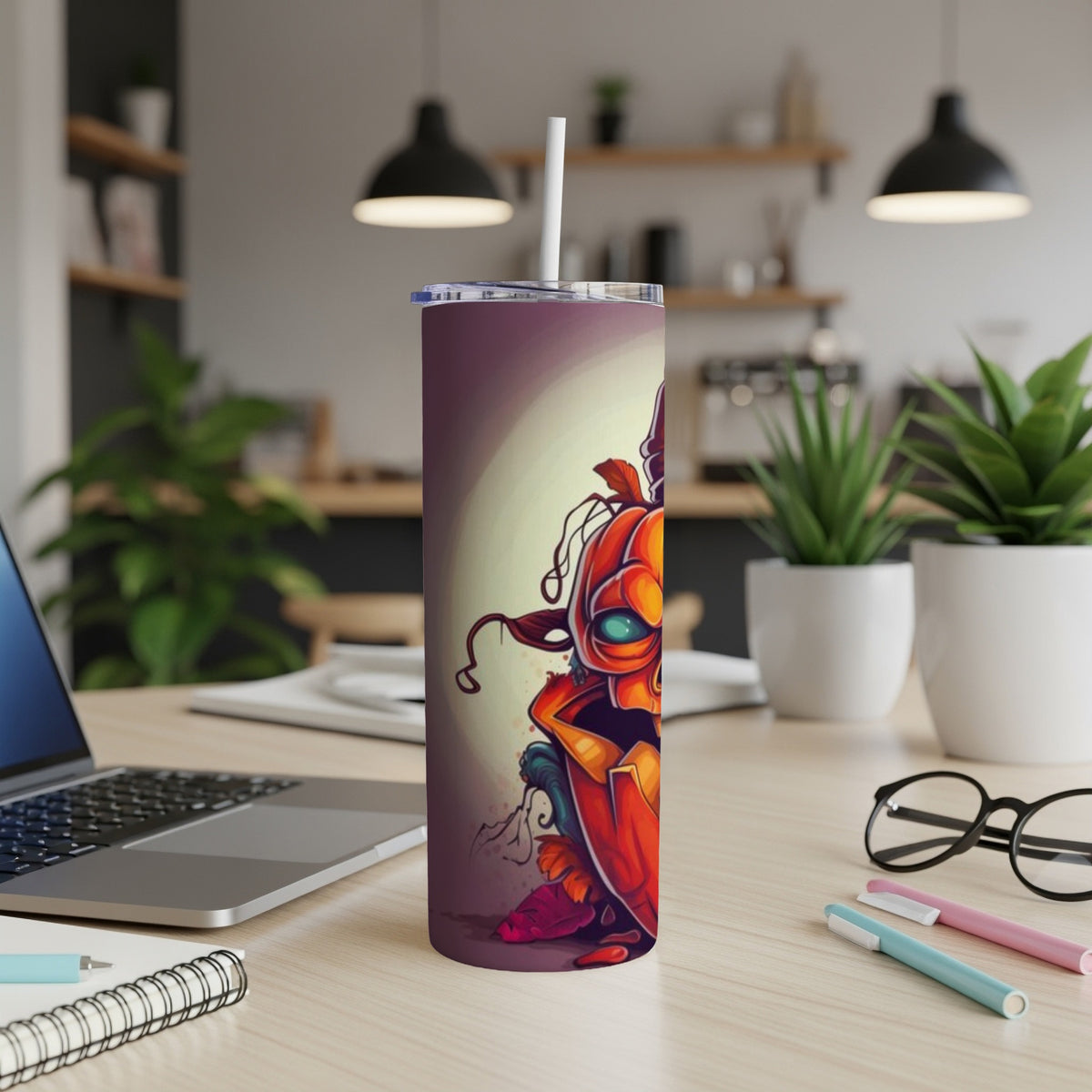 Tumbler with a spooky Halloween pumpkin illustration and a white straw.