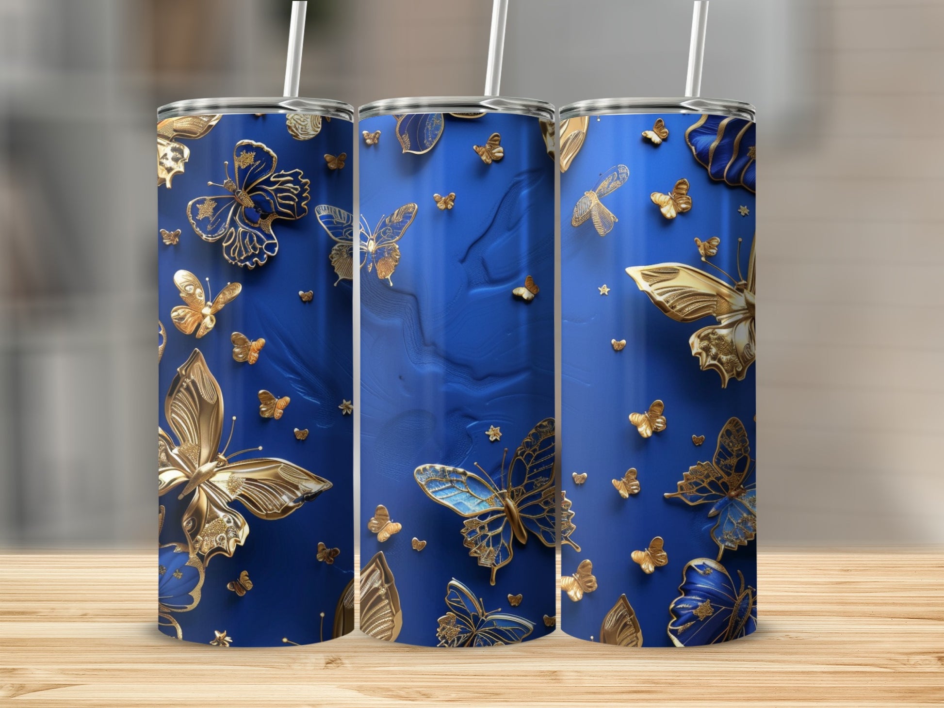 Blue tumbler with gold and blue butterflies and gold trim.
