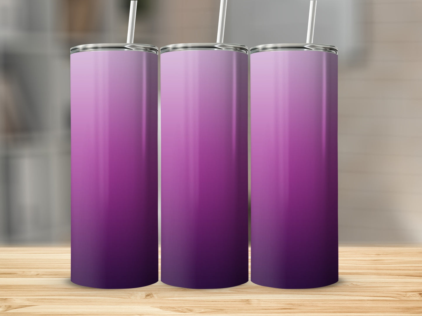 Three tumblers with a purple gradient design on a wooden surface.