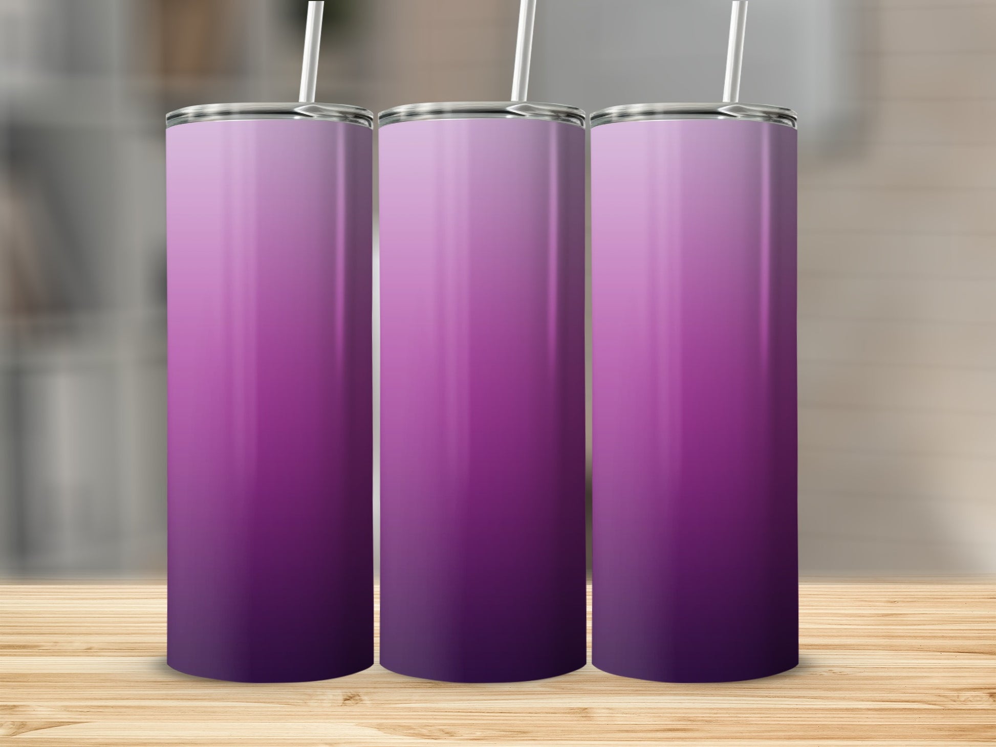 Three tumblers with a purple gradient design on a wooden surface.