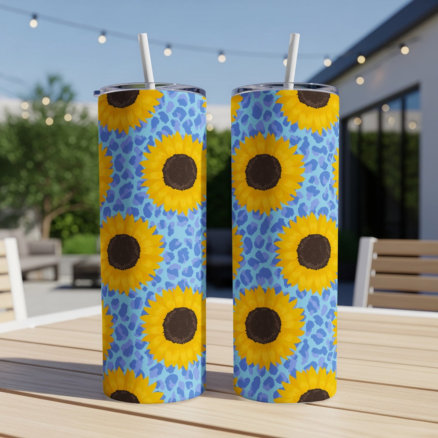Two tall tumblers with a blue leopard print and sunflower pattern.