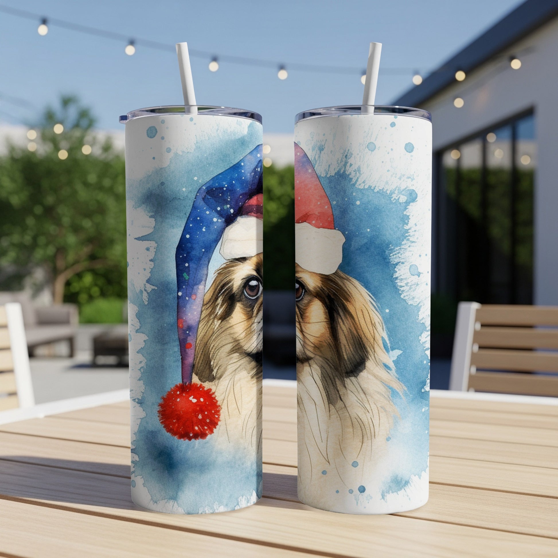 Two tall, skinny tumblers featuring a watercolor painting of a shih tzu wearing a Santa hat.
