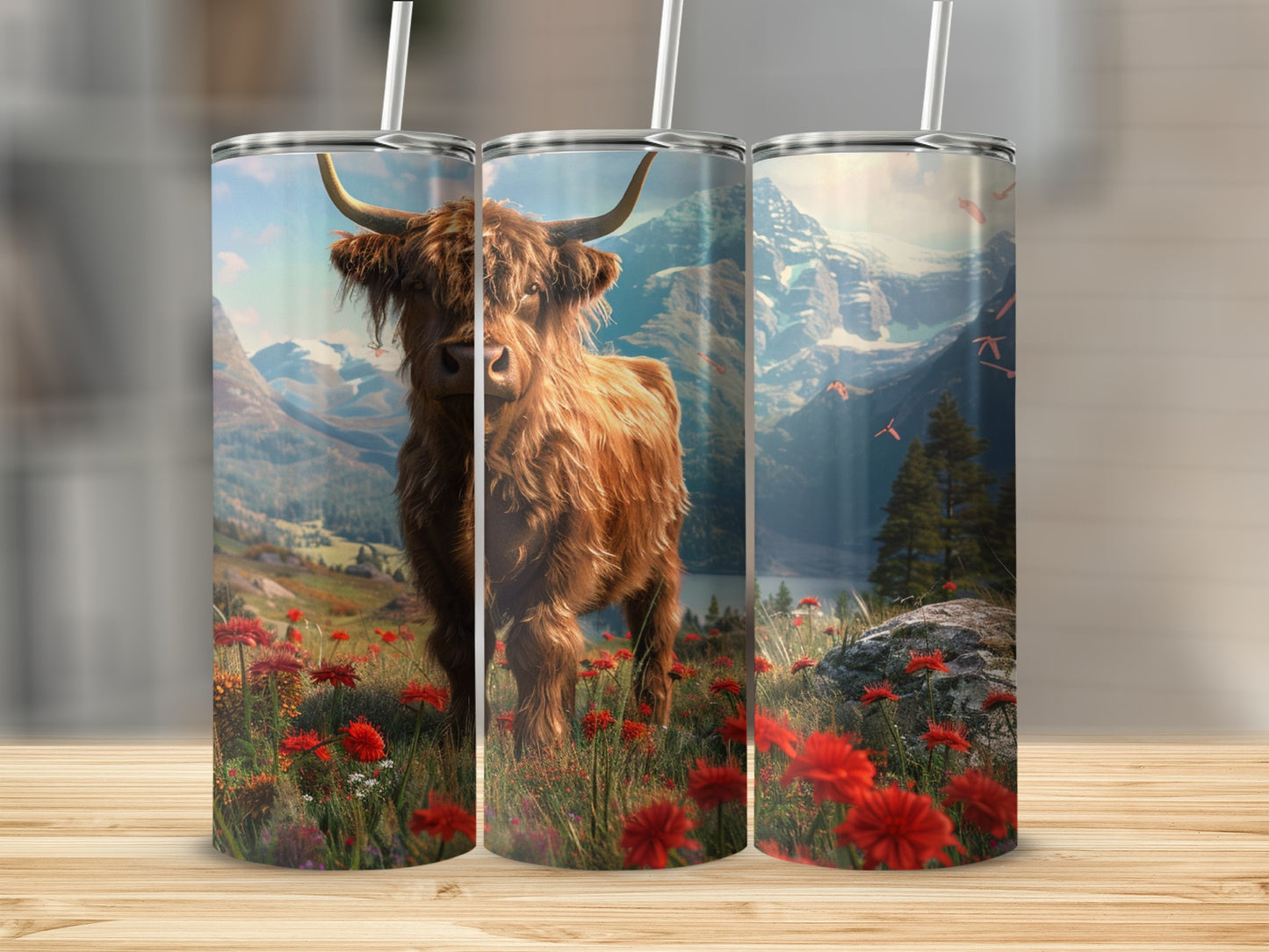 Highland cow in a field of red wildflowers with mountains in background.