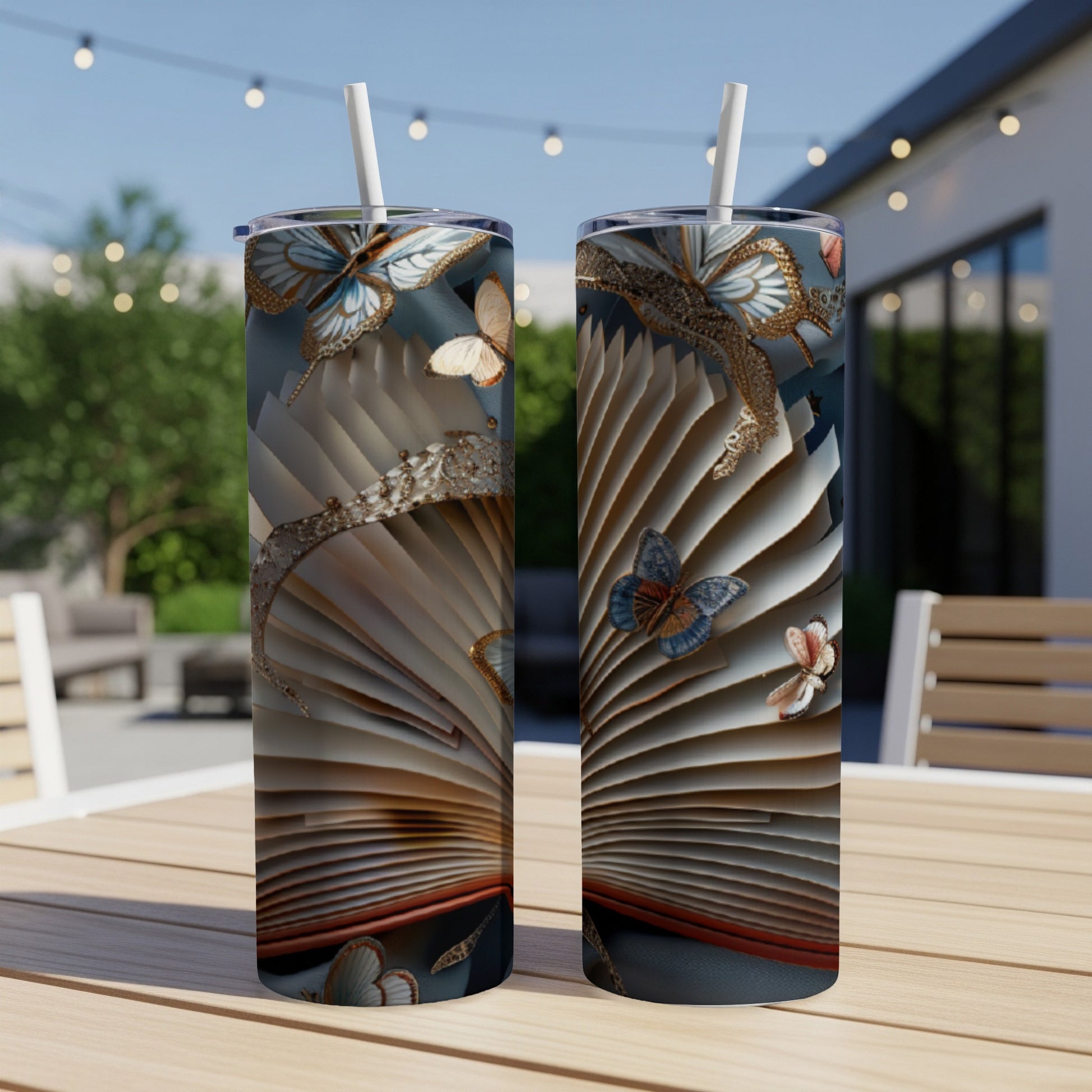 Open book with ornate pages and butterflies, two tumblers on a table.