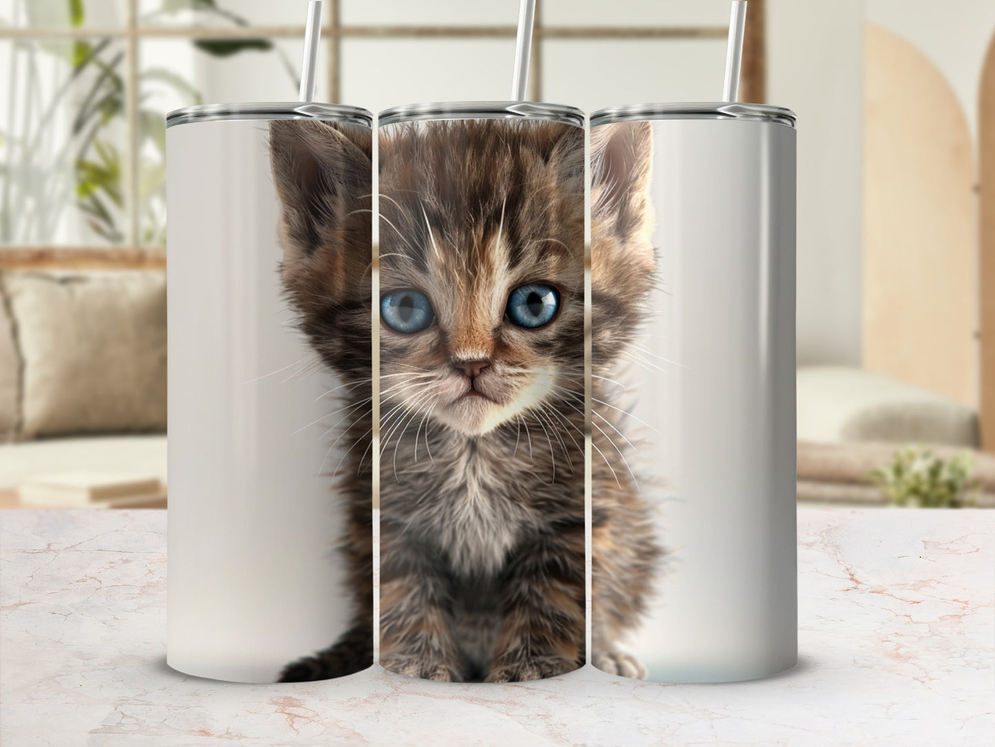 Close-up of a fluffy kitten with wide blue eyes on a tumbler design.