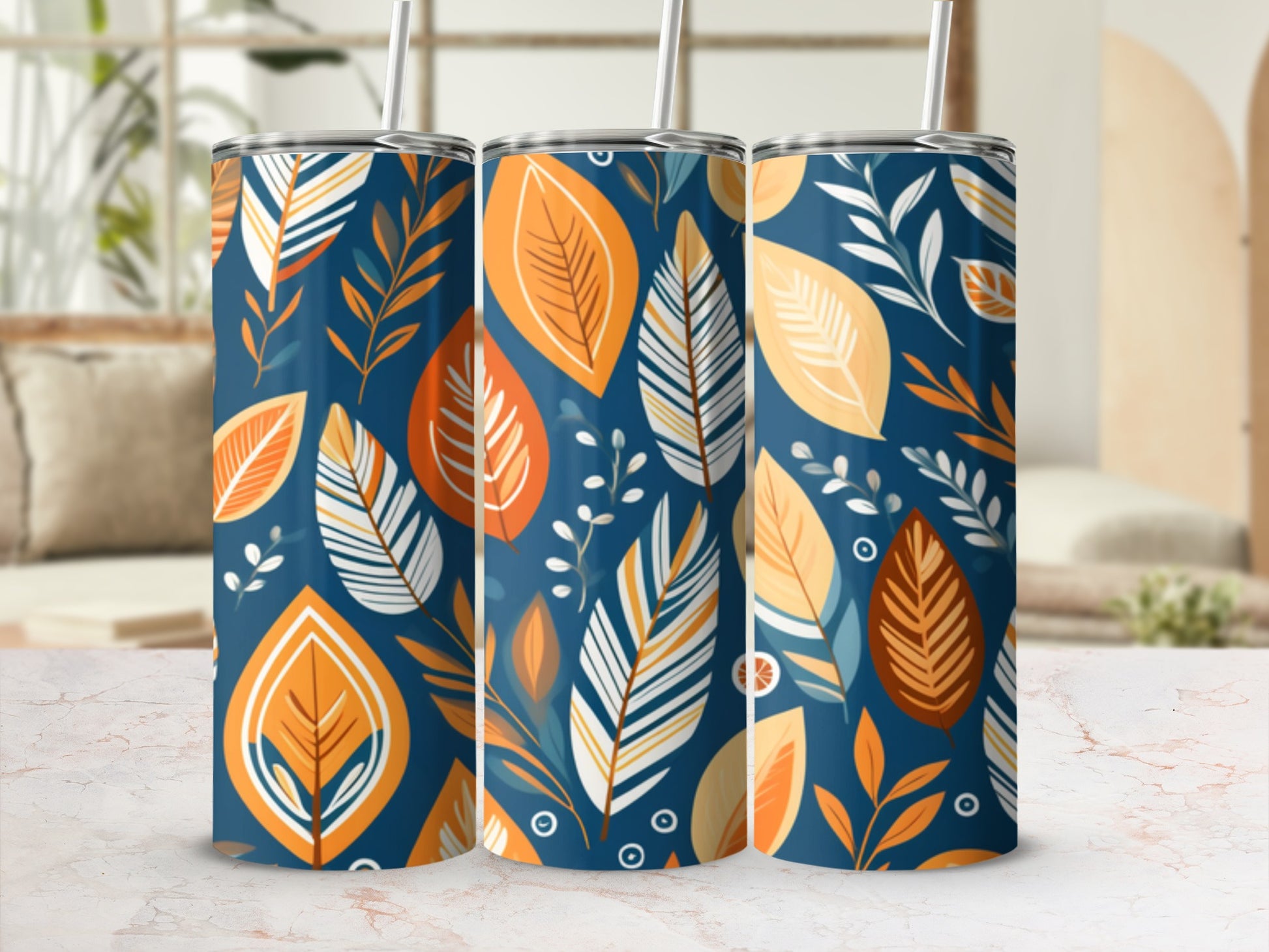 Three tall tumblers with a navy blue background and an orange and beige leaf pattern.