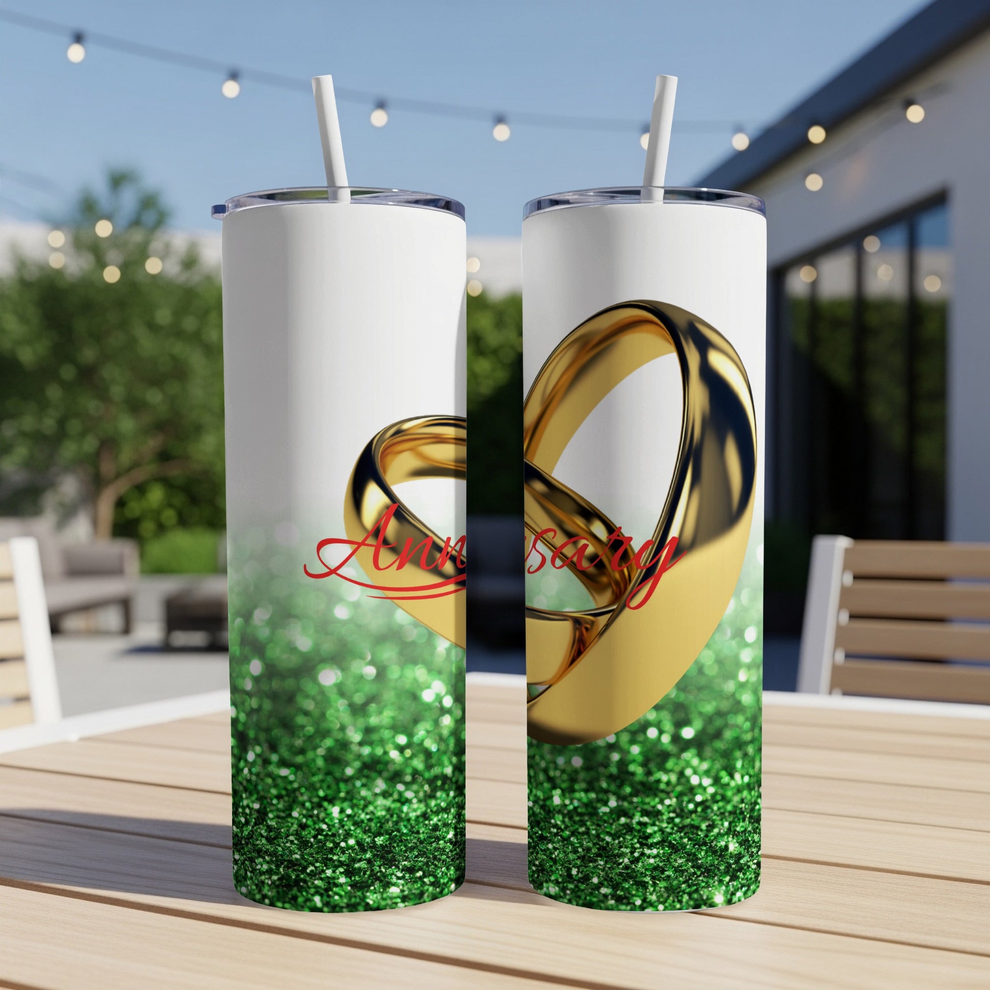 Two tumblers with gold rings and "Anniversary" text on green glitter.