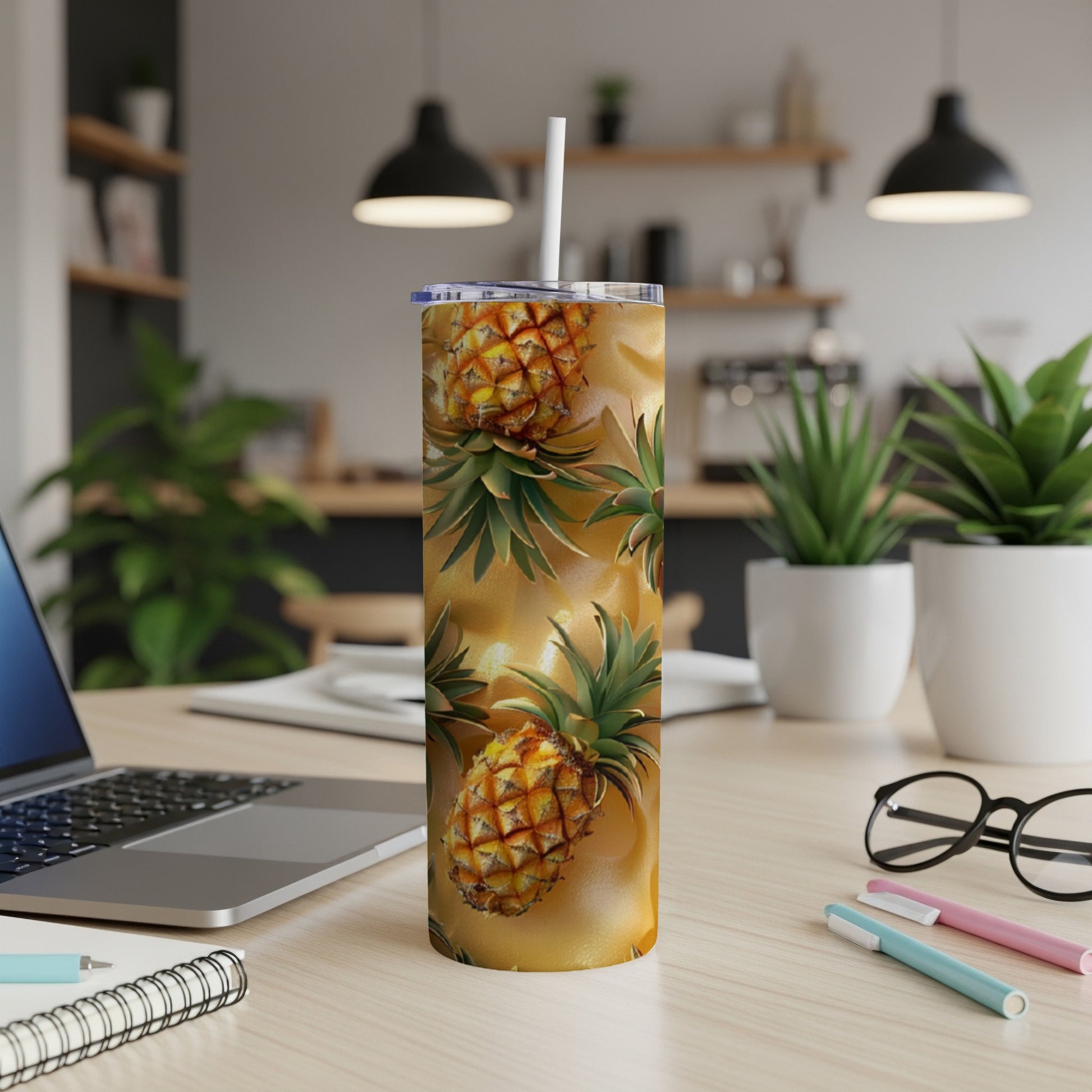 Pineapple pattern tumbler with white straw on a desk.