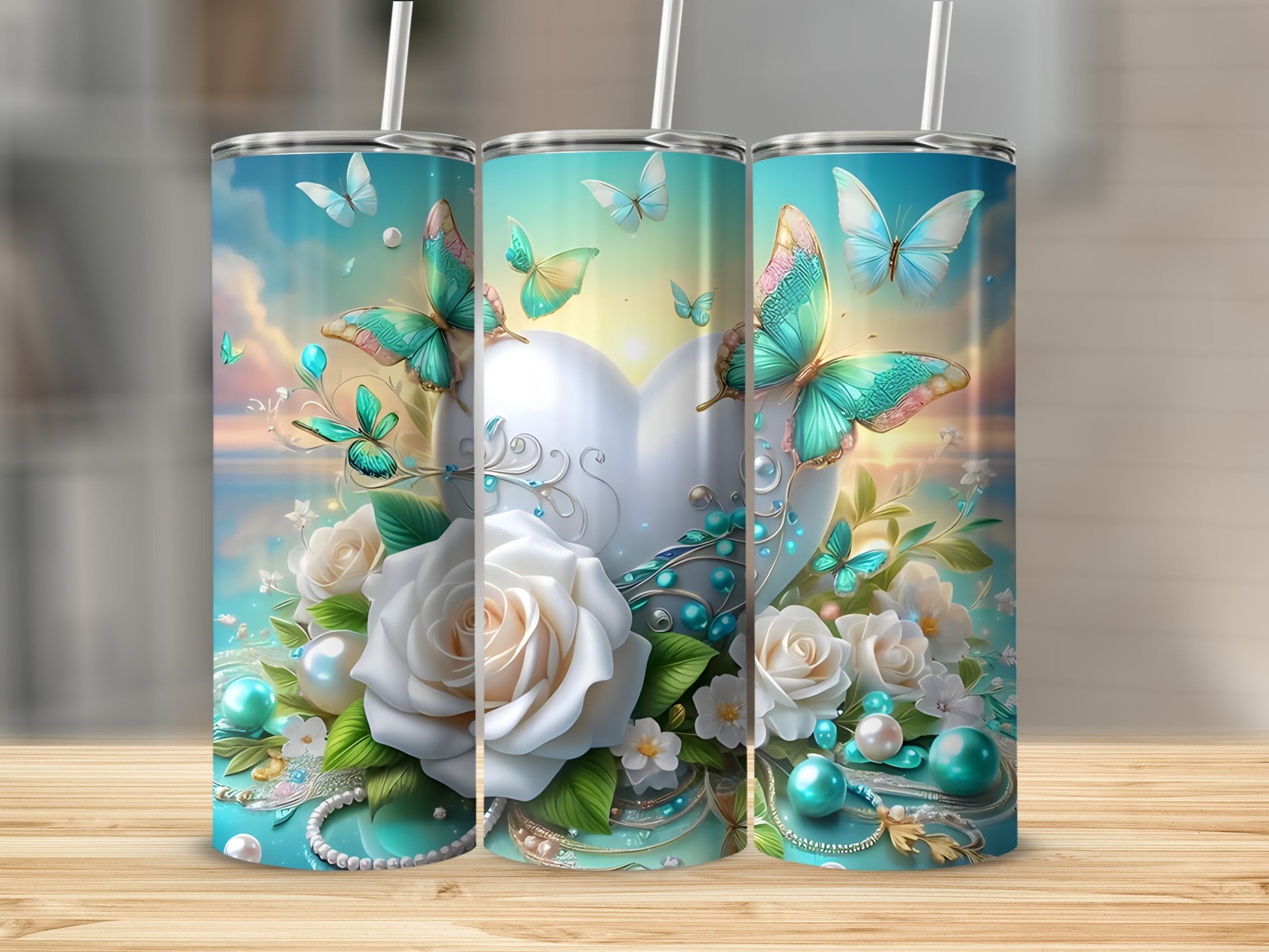 Three tumblers with a white heart, roses, and teal butterflies.