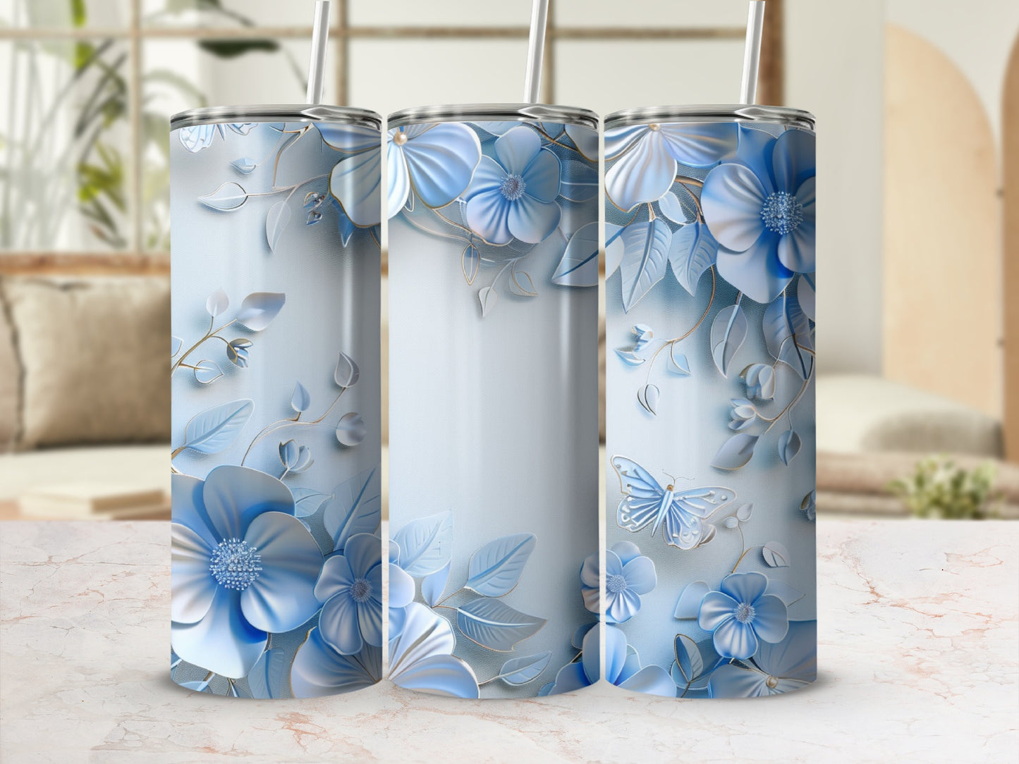 Three tumblers with blue floral designs and a butterfly.