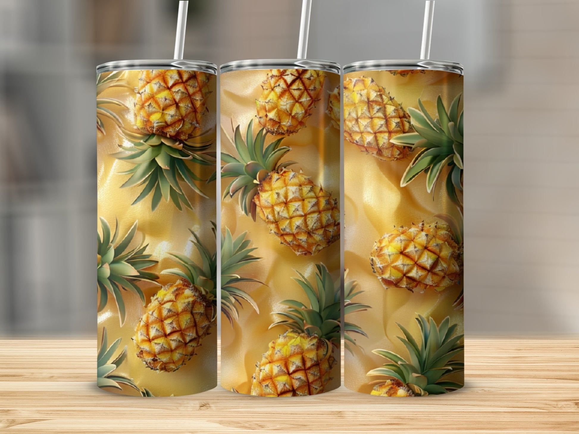 Three tumblers with a repeating pineapple pattern on a wooden surface.