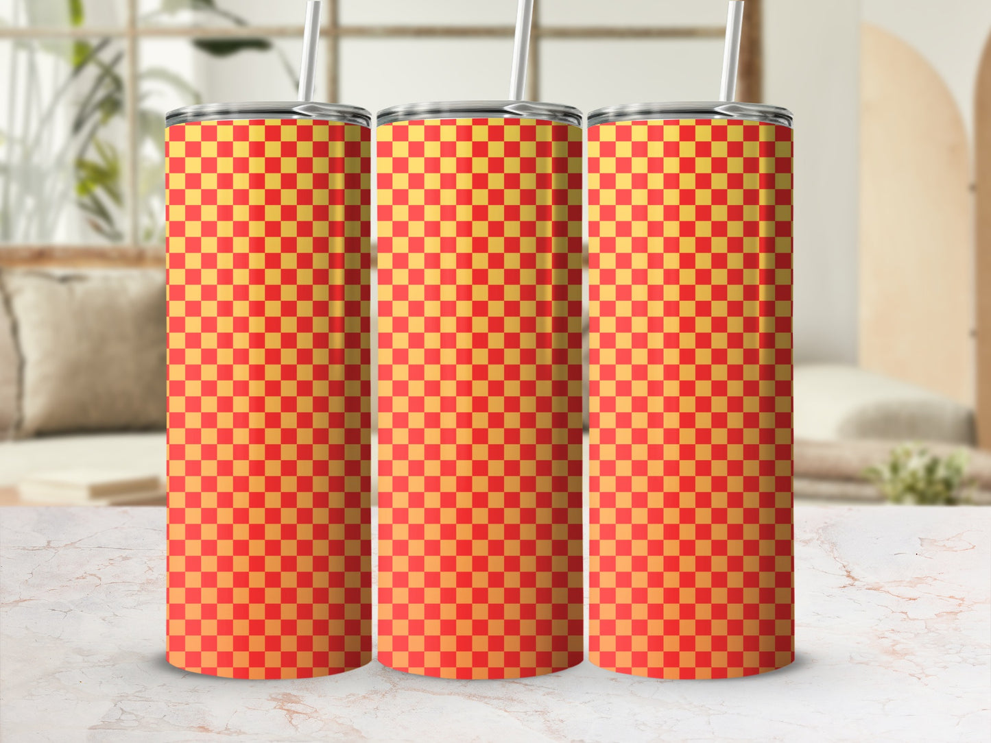 Three red and yellow checkered tumblers with straws.