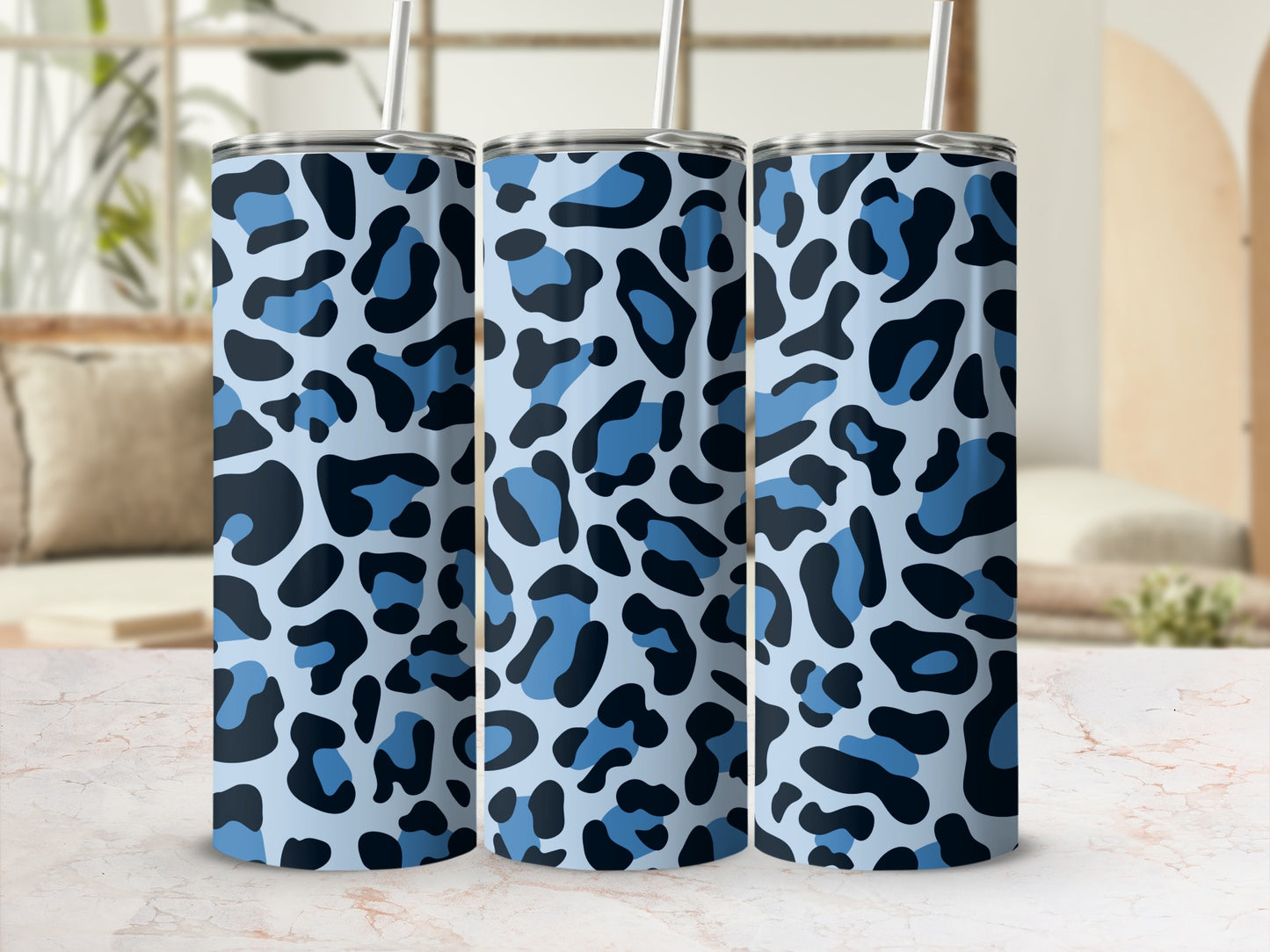 Three tall cups with a blue and black leopard print pattern and silver lids.