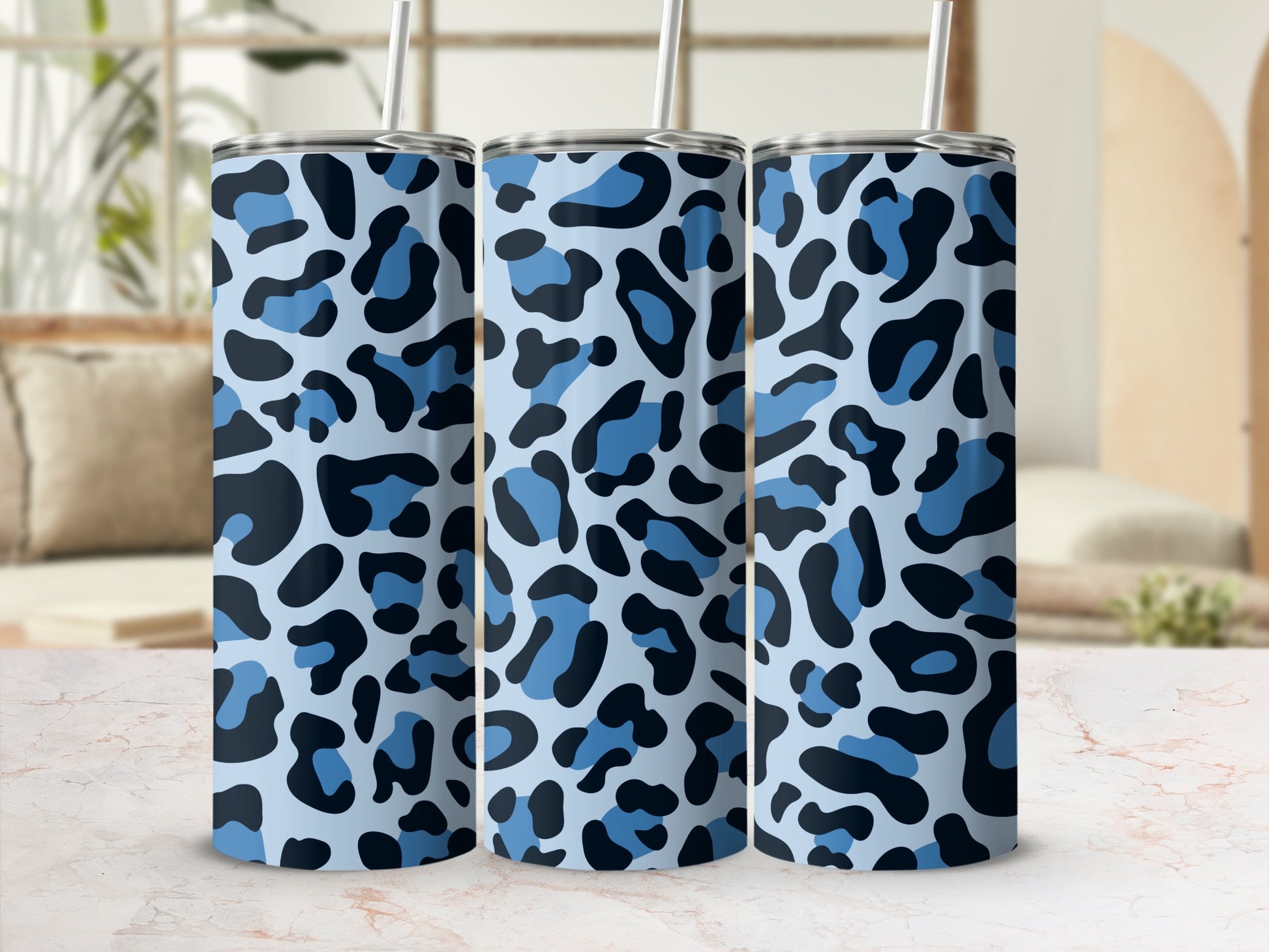 Three tall cups with a blue and black leopard print pattern and silver lids.
