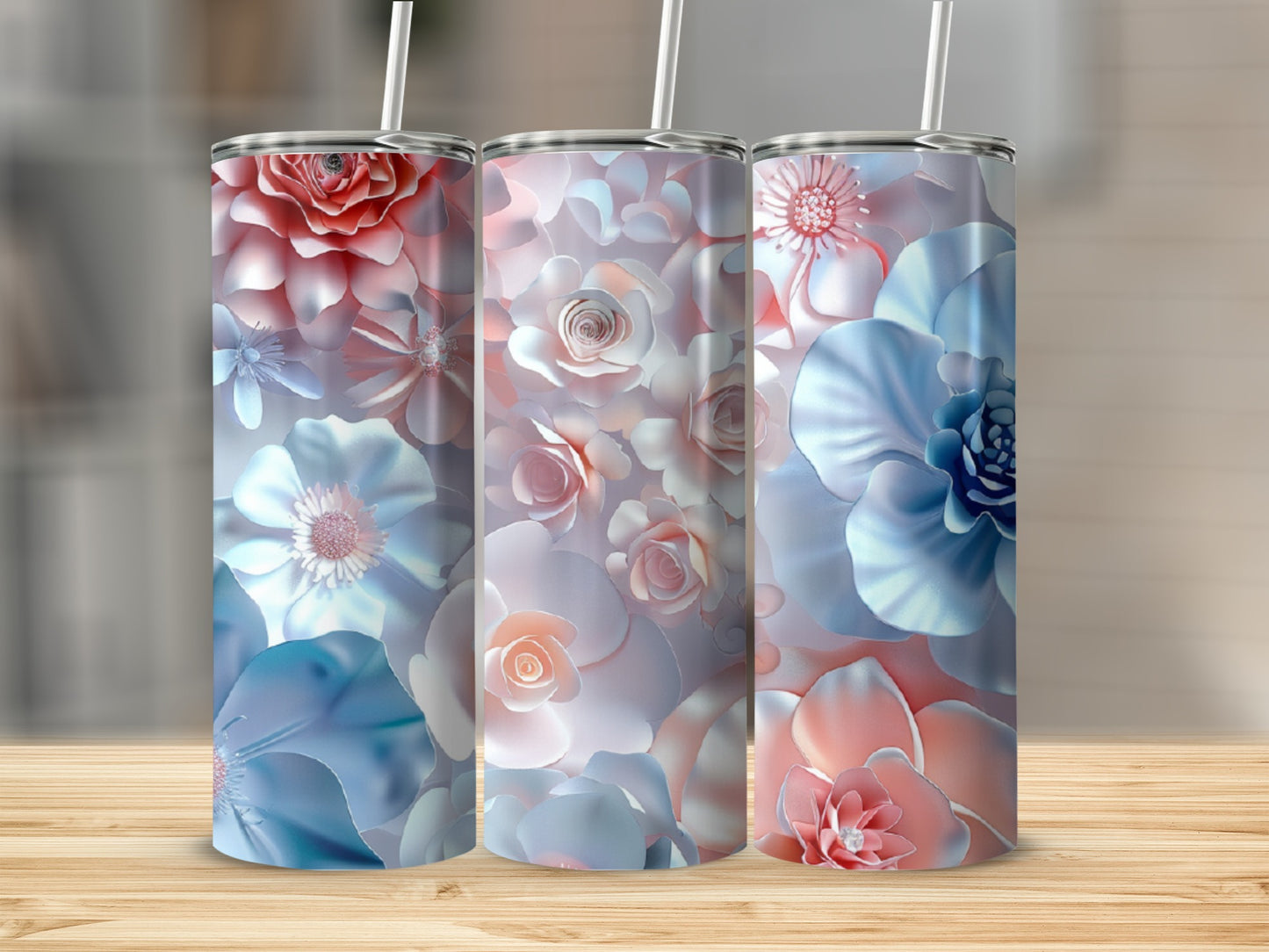 Three tall tumblers with a floral design in shades of pink and blue.