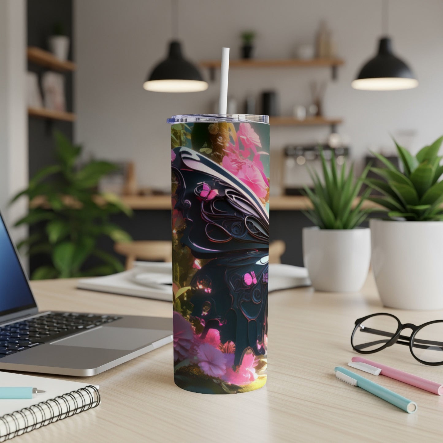 Pink and black butterfly wings with flowers on a skinny tumbler.