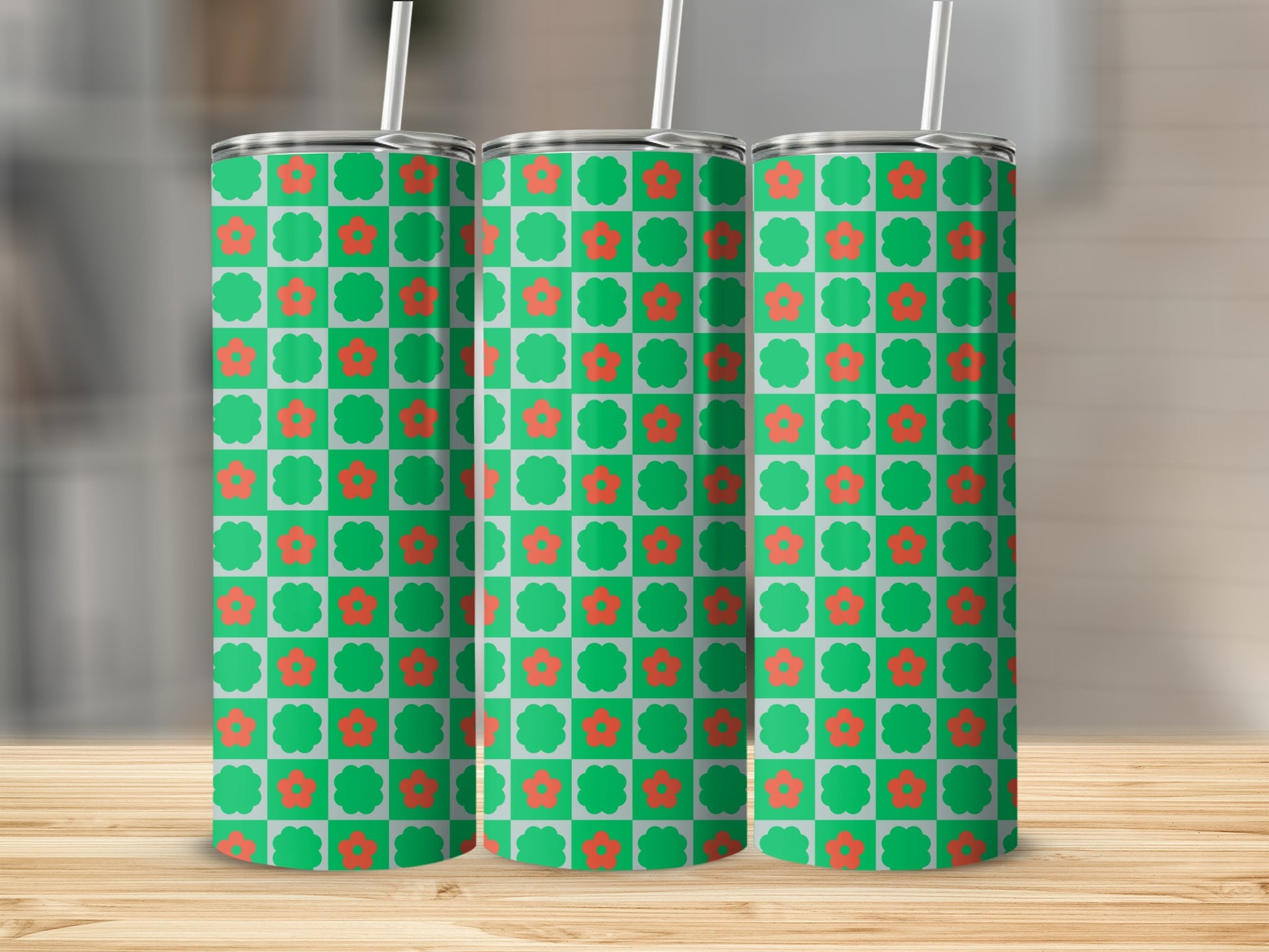Green tumbler with a red flower and checkered pattern.