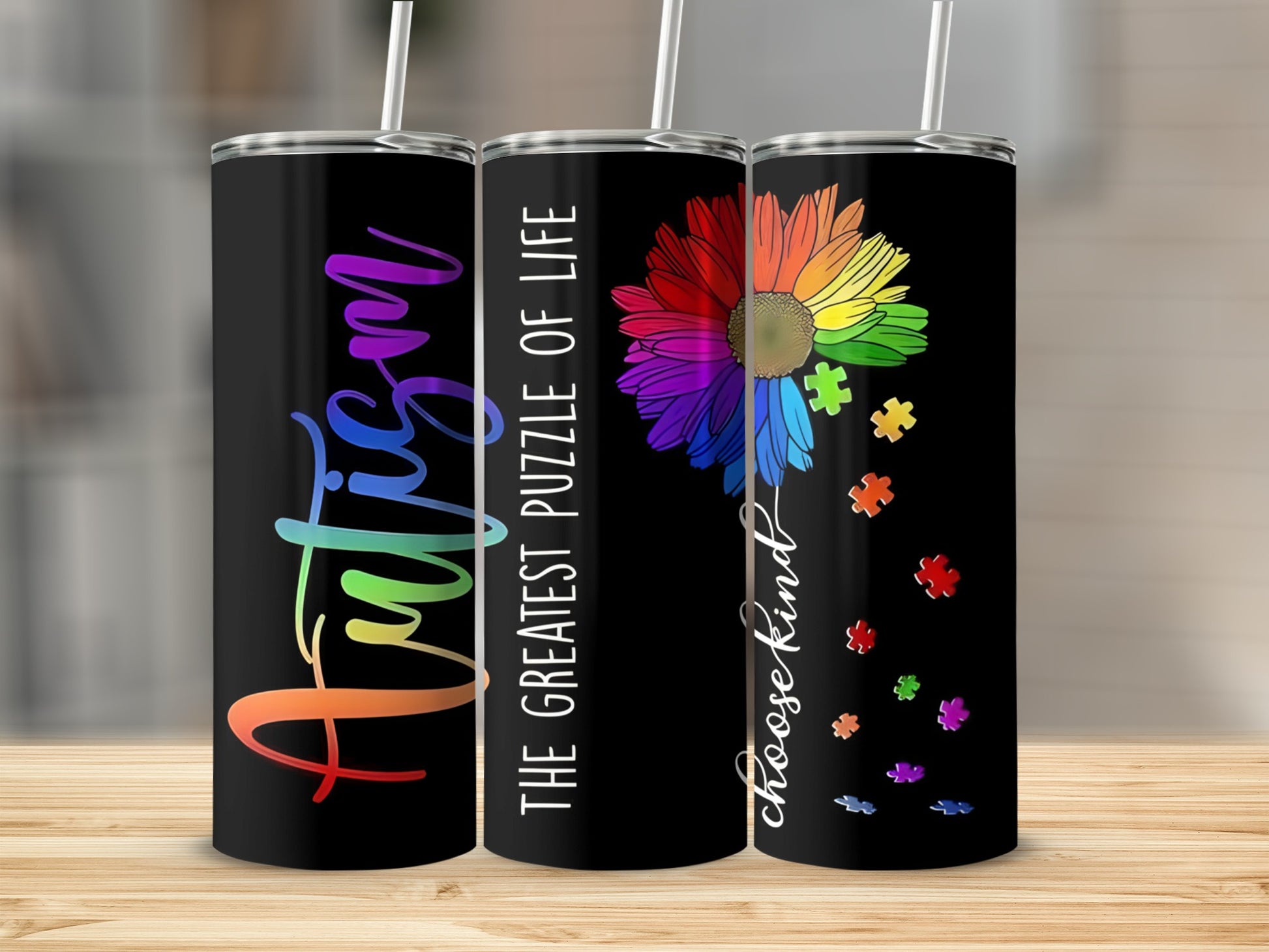 Black tumbler with "Autism" in colorful letters and rainbow puzzle flower.