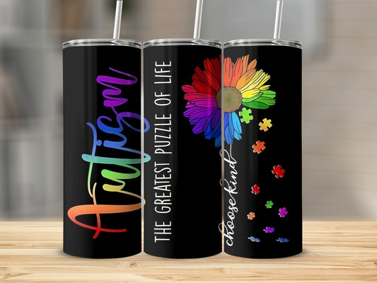 Black tumbler with "Autism" in colorful letters and rainbow puzzle flower.