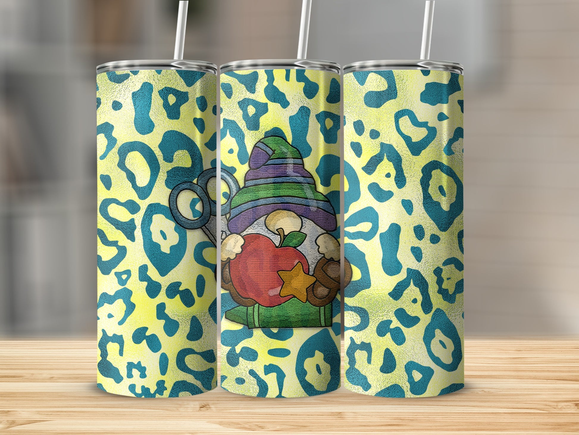 Leopard print tumbler with gnome, apple, and scissors design.