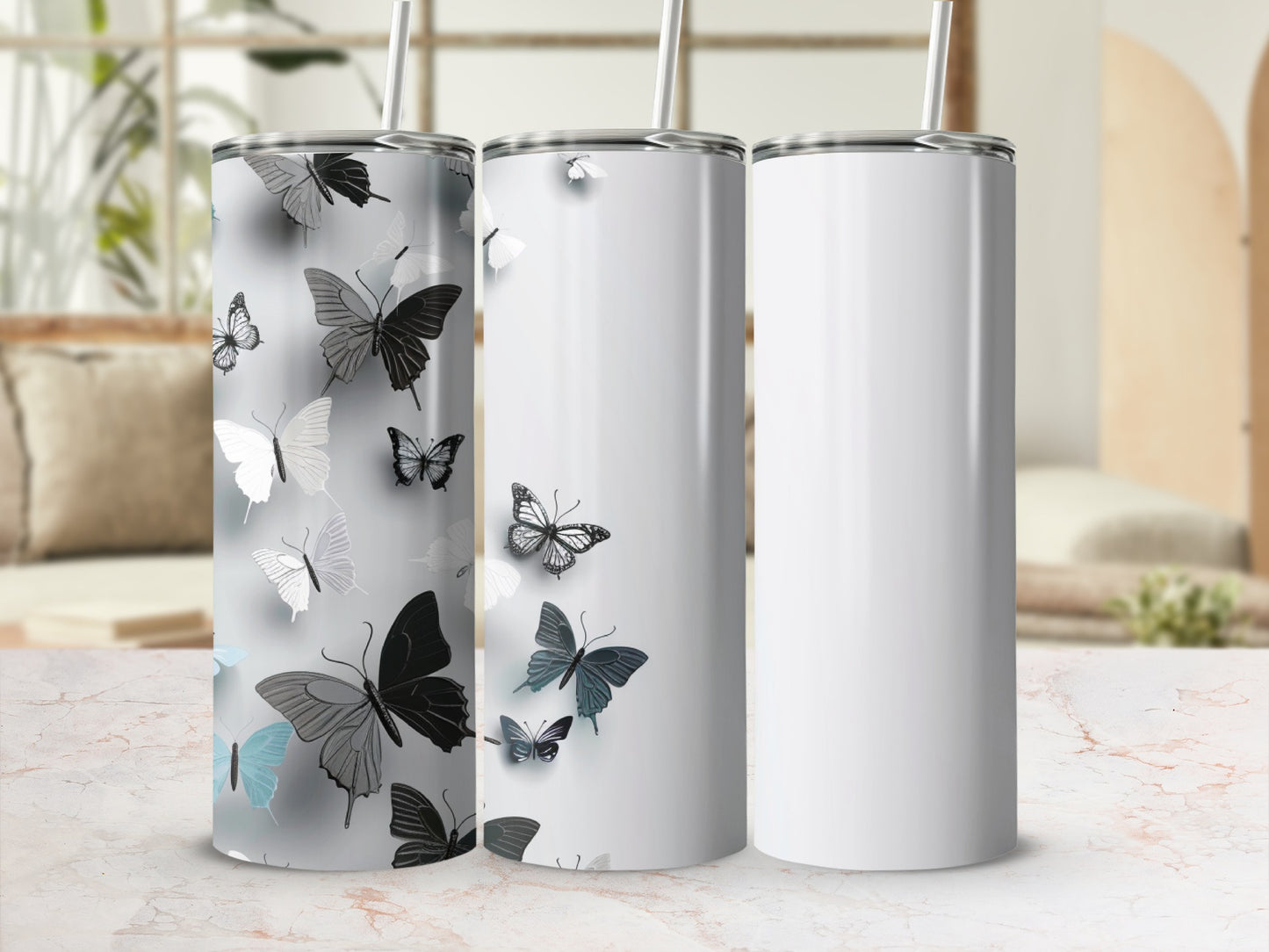 Three white tumblers with butterfly designs and one blank.