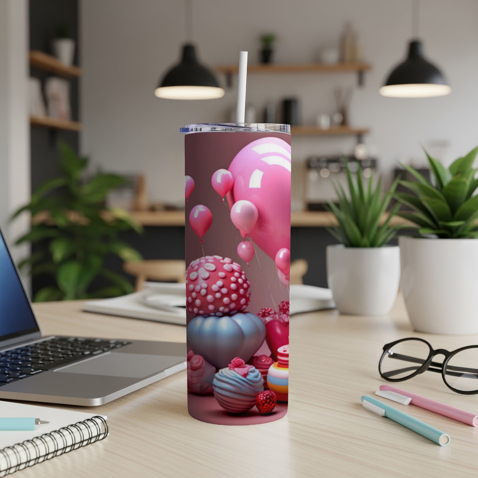Pink balloons, cupcakes, and party favors on a pink tumbler.