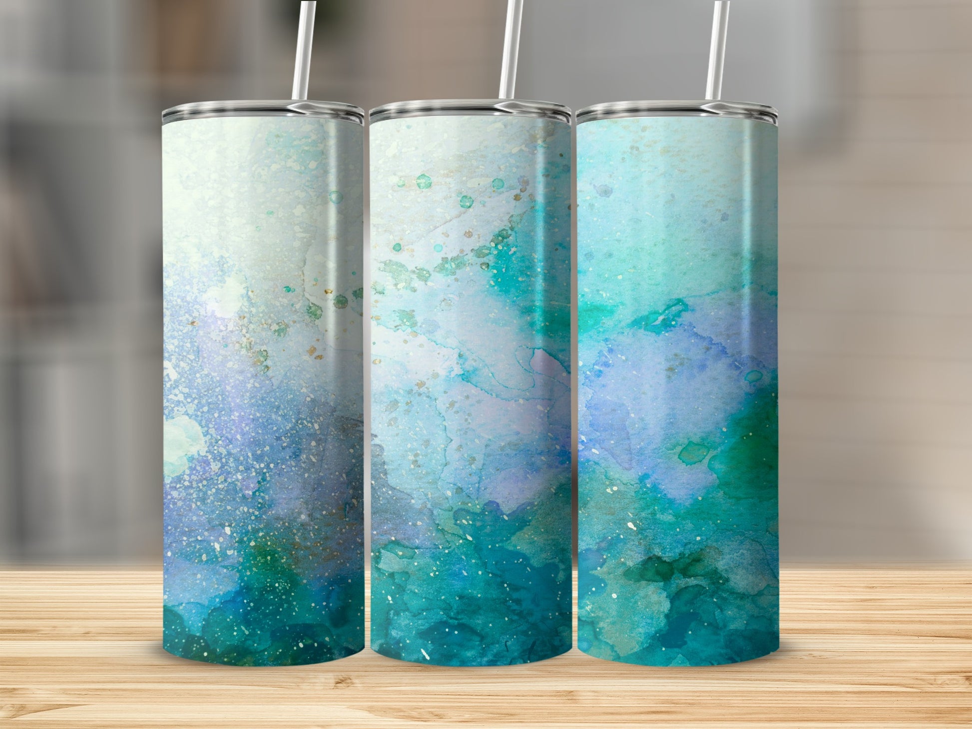 Three tumblers with abstract teal and blue watercolor designs.