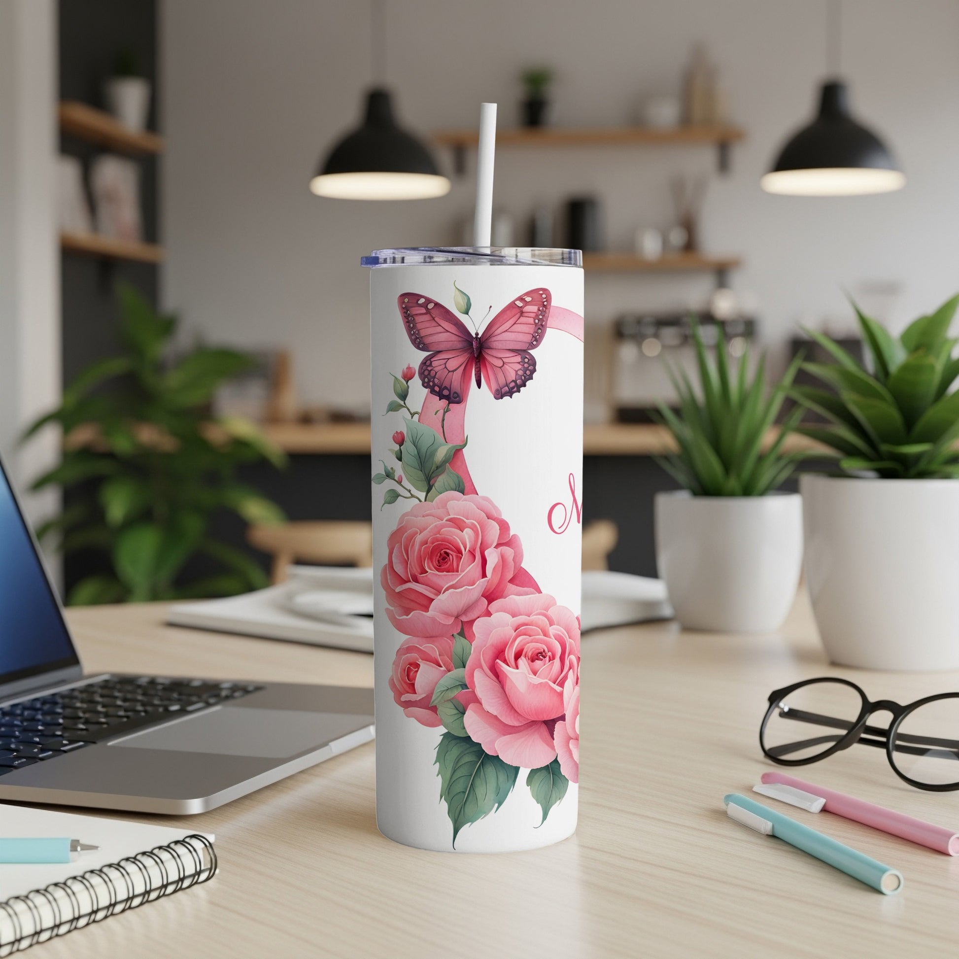 White tumbler with pink roses and butterfly design, straw included.