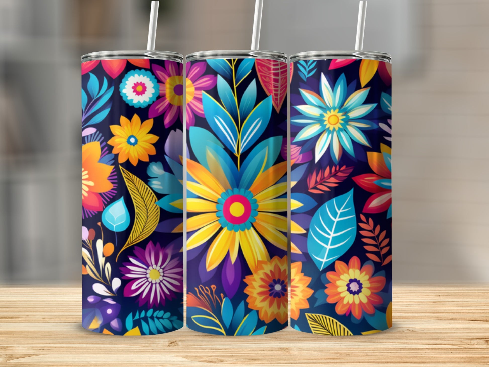 Three tumblers with a vibrant floral pattern featuring blue, yellow, and orange flowers.