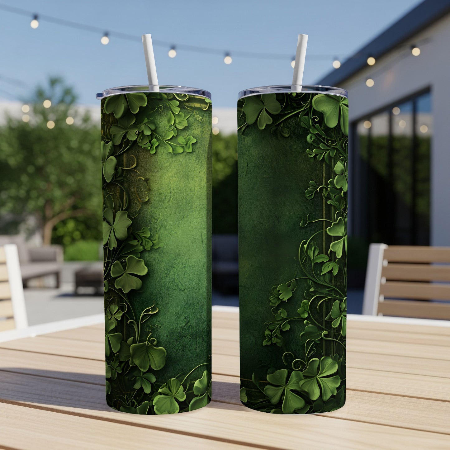 Two green tumblers with shamrock vine pattern and white straws.