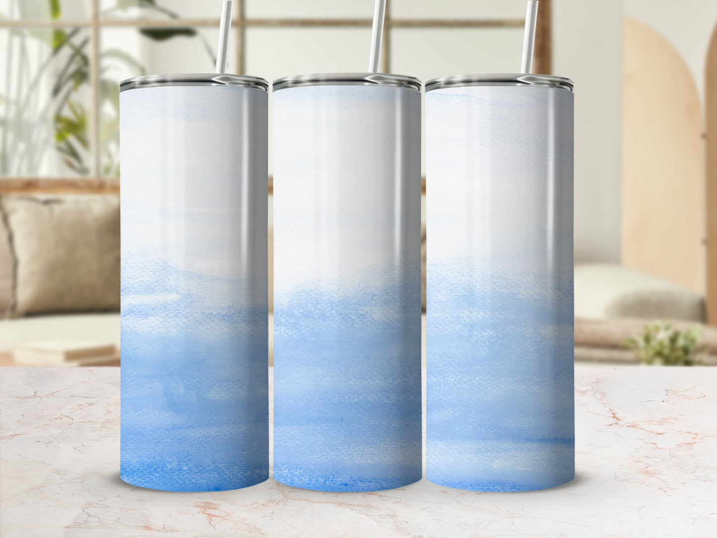 Three tall, skinny tumblers with a watercolor blue design.