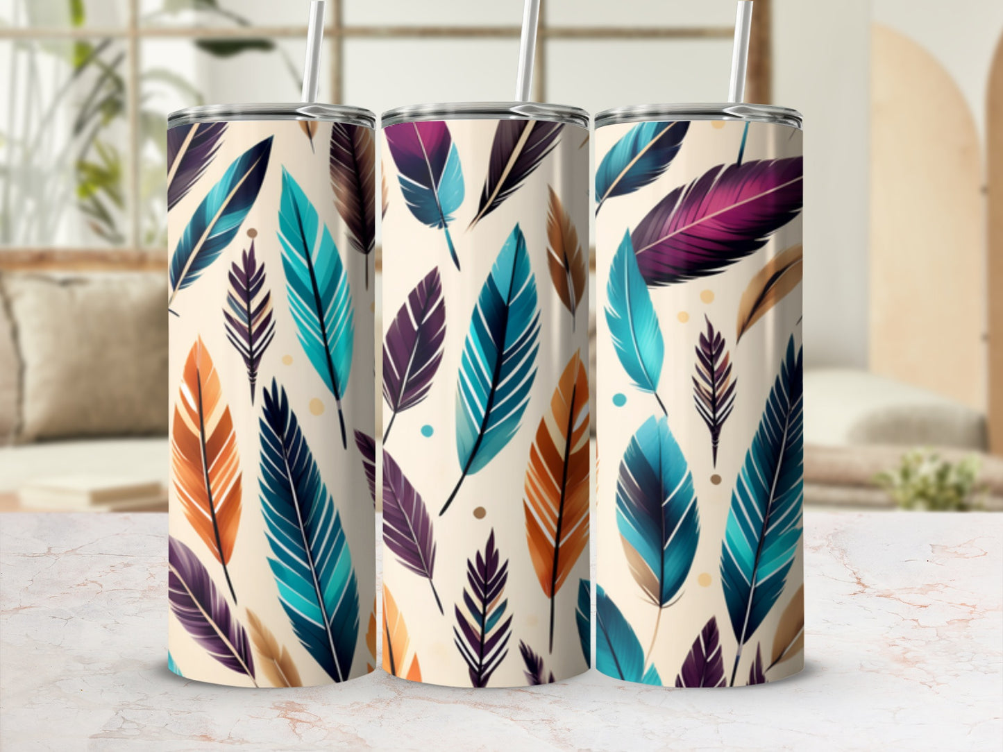 Three tumblers with colorful feather designs and reusable straws.