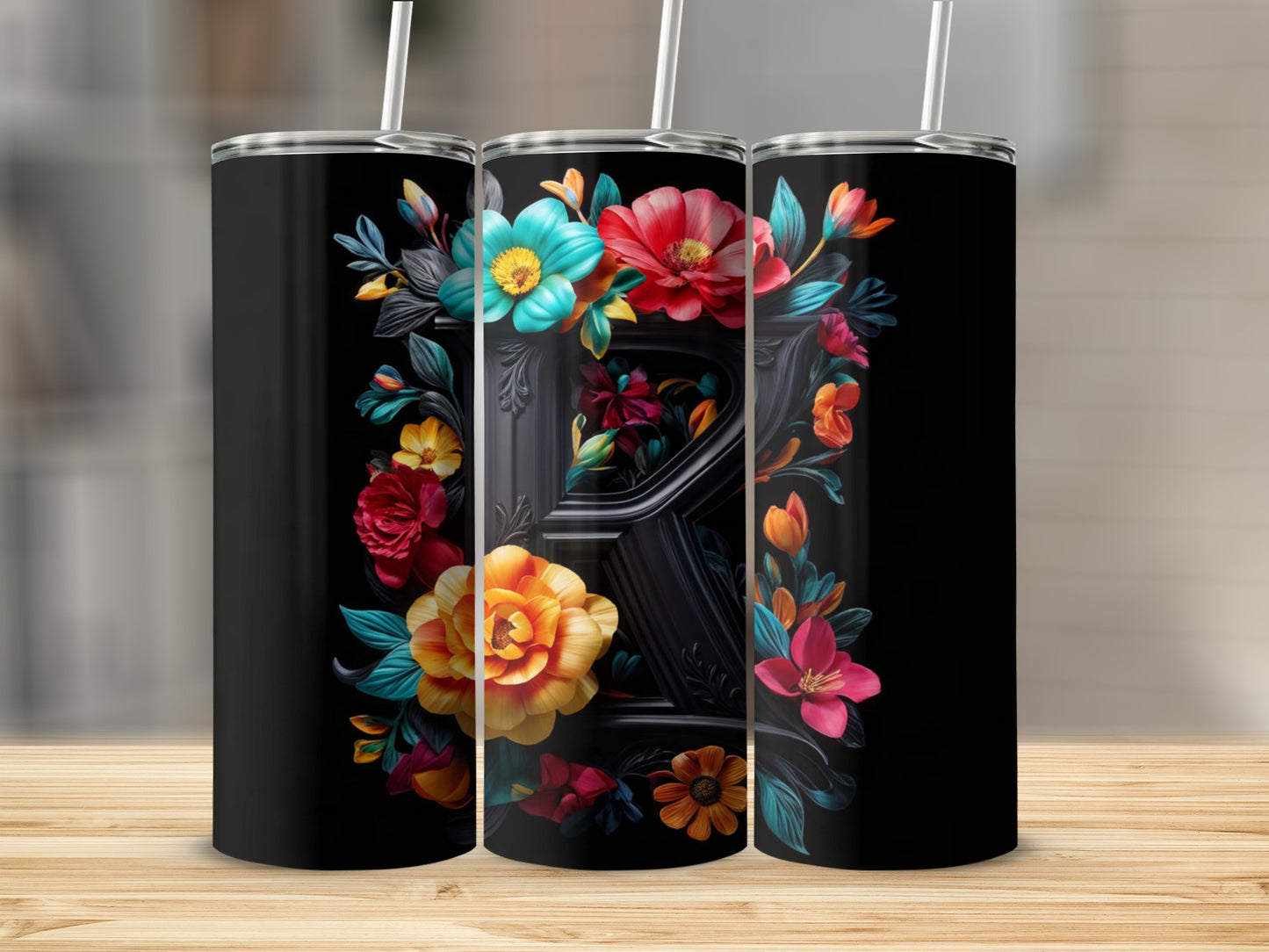 Black tumbler with a decorative floral initial "R" design.