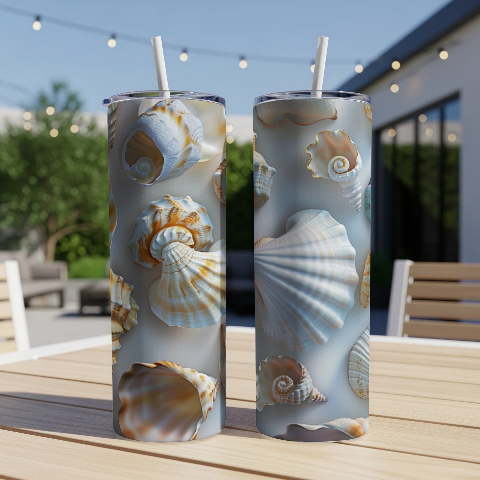 Two tall, insulated tumblers with a pattern of various seashells.