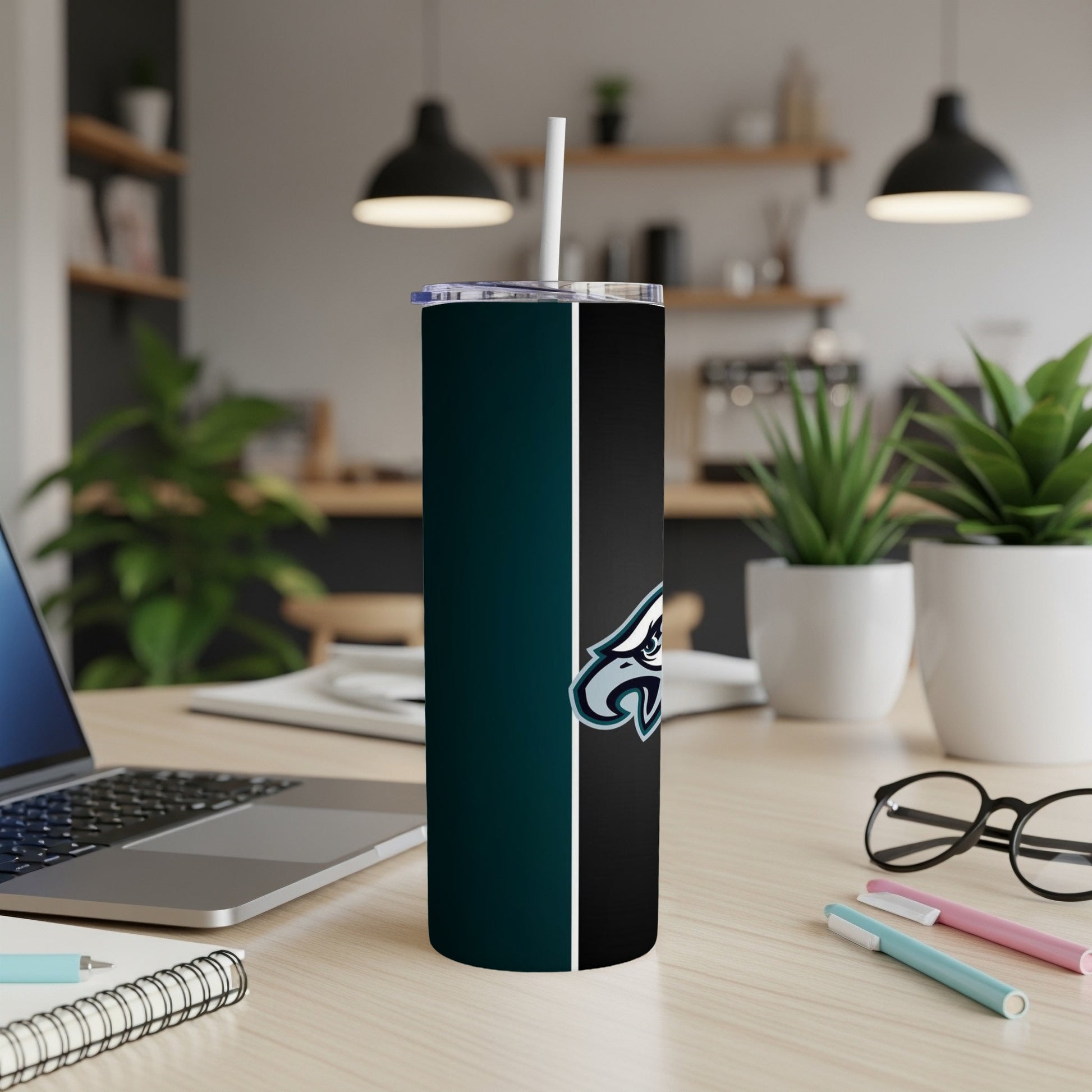 Philadelphia Eagles logo on a teal and black skinny tumbler.