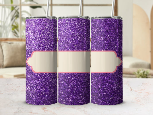 Three purple glitter tumblers with light-colored labels sit on a marbled surface.