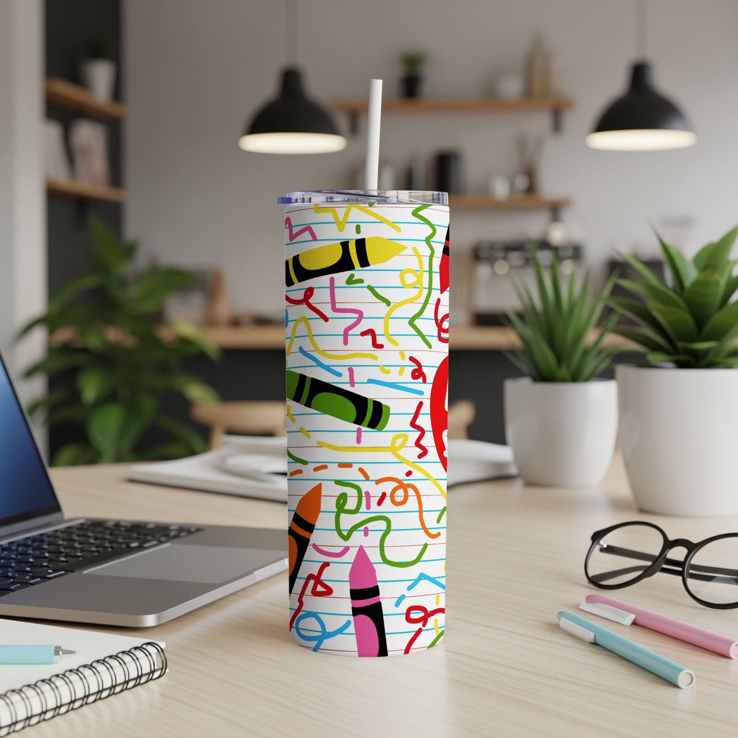 Tumbler with crayon and squiggly line pattern on lined paper background.